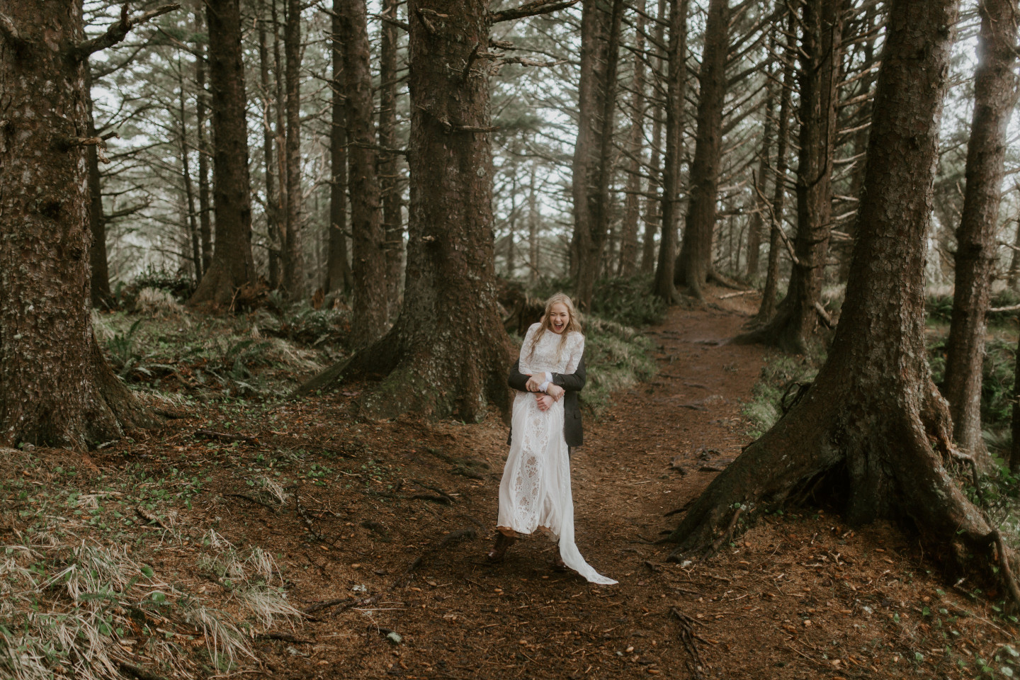 Grant lifts Hannah up during their Oregon coast elopement. Wedding photography in Portland Oregon by Sienna Plus Josh.