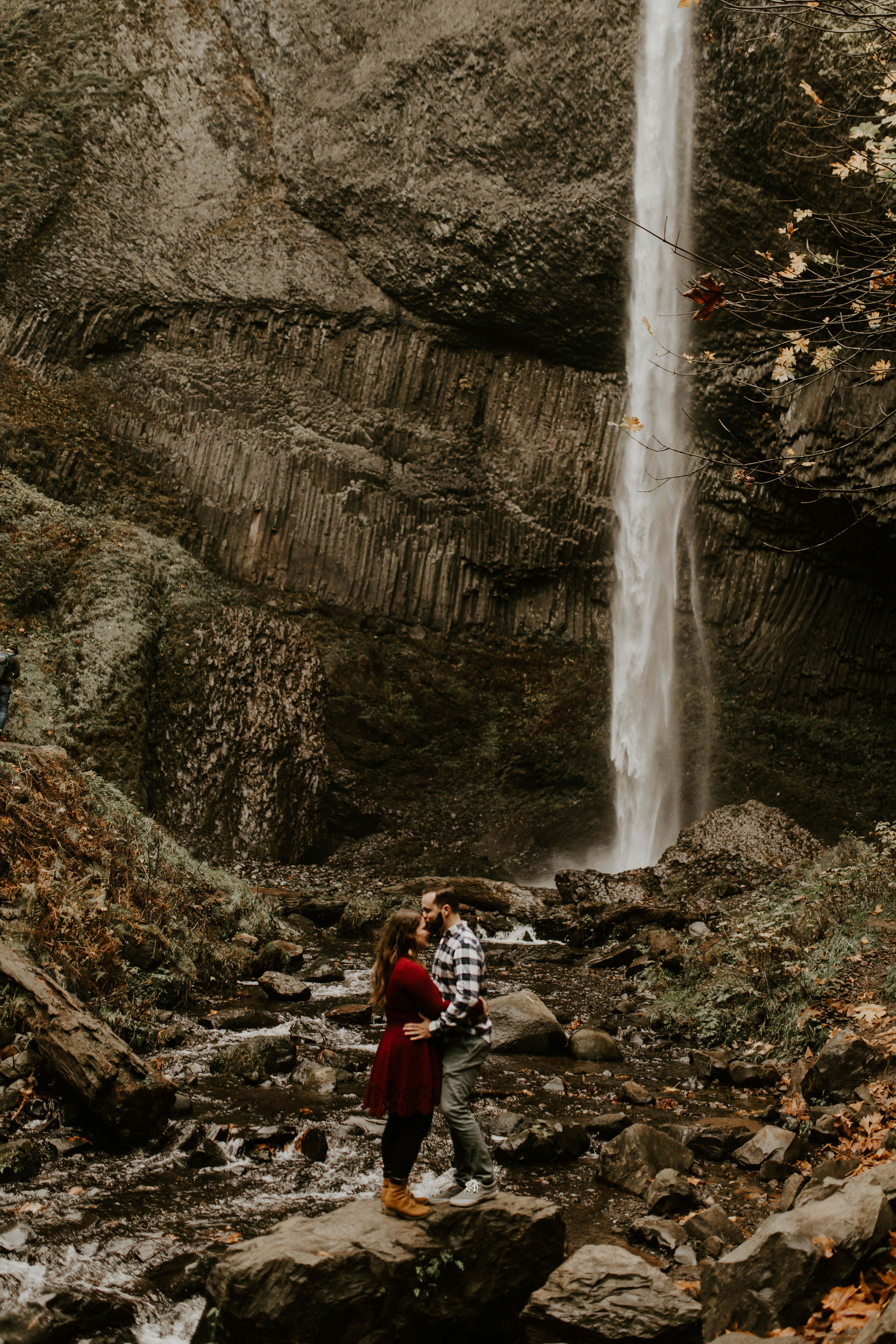 Allison and Brandon hold each other in front of Latourell Falls. Engagement shoot by Sienna Plus Josh.