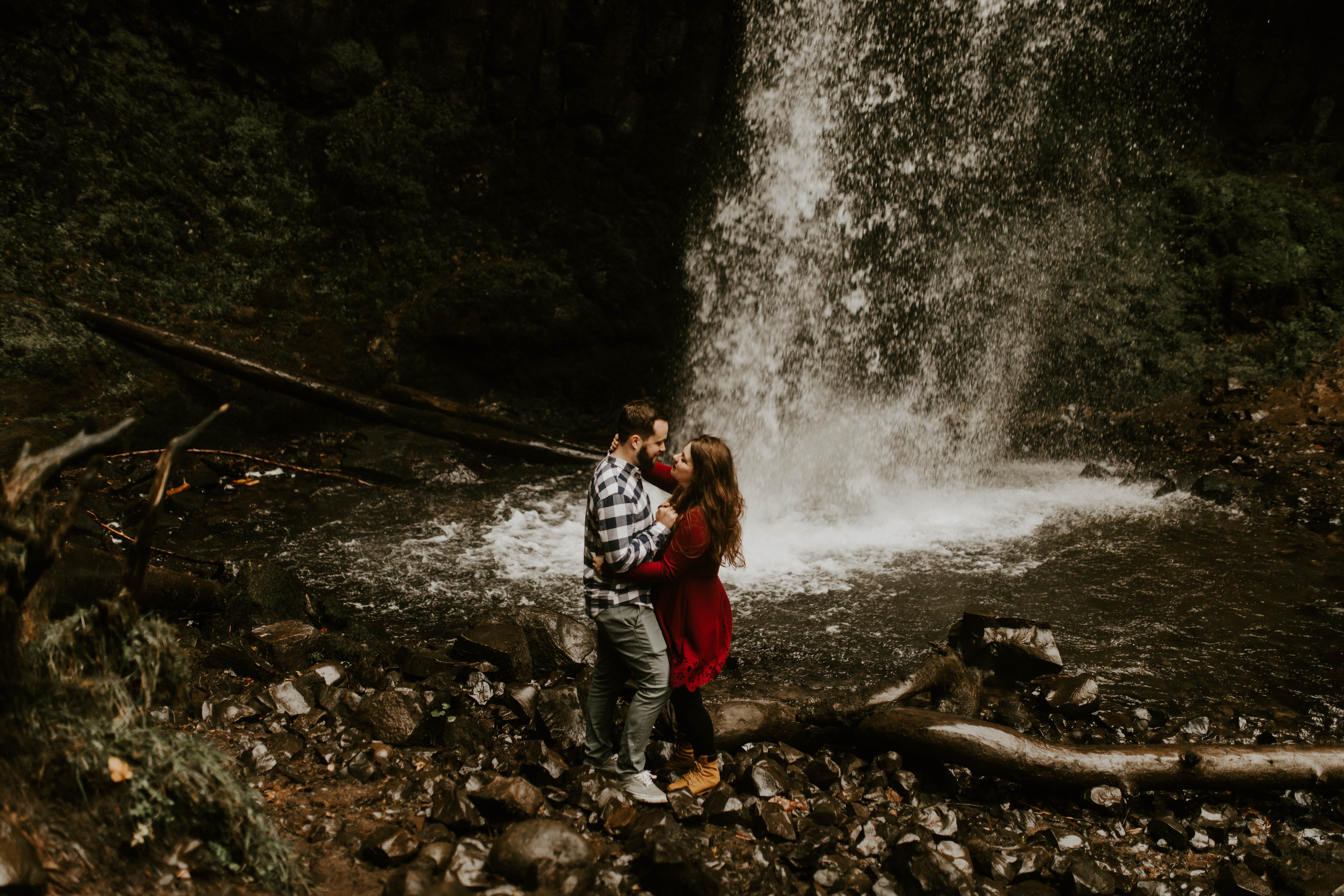 Allison and Brandon move in for a kiss at Latourell Falls. Engagement shoot by Sienna Plus Josh.