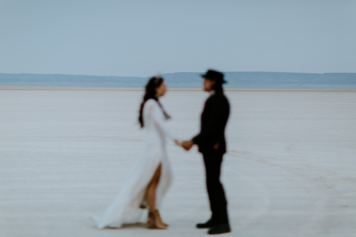 Emerald and Cameron stand in the vast Alvord Desert in Central Oregon.