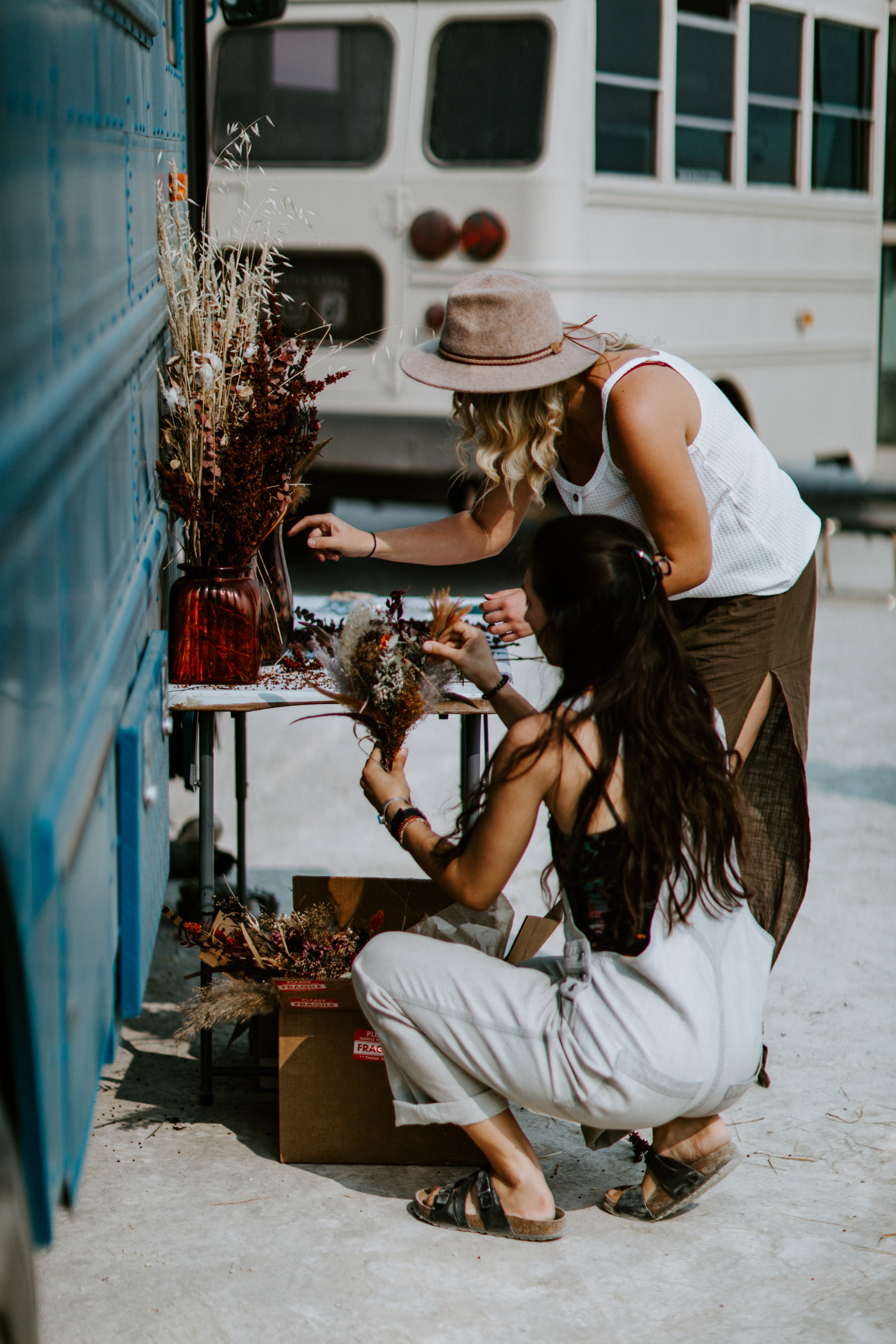 Emerald and her friend prepare the dried flowers for the elopement.