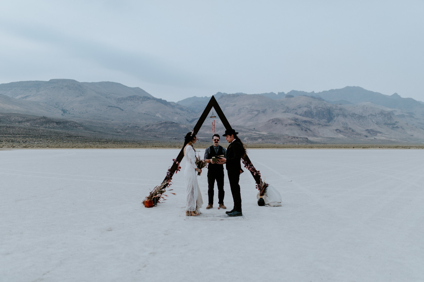 Emerald and Cameron stand in the Alvord Desert during their elopement.