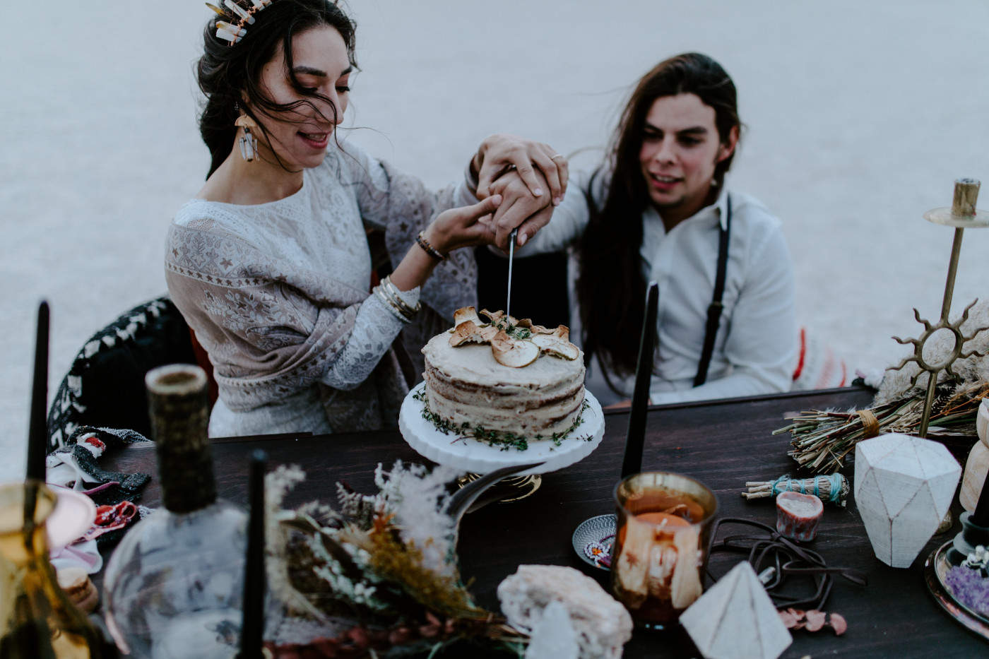 Cameron and Emerald cut their elopement cake together.