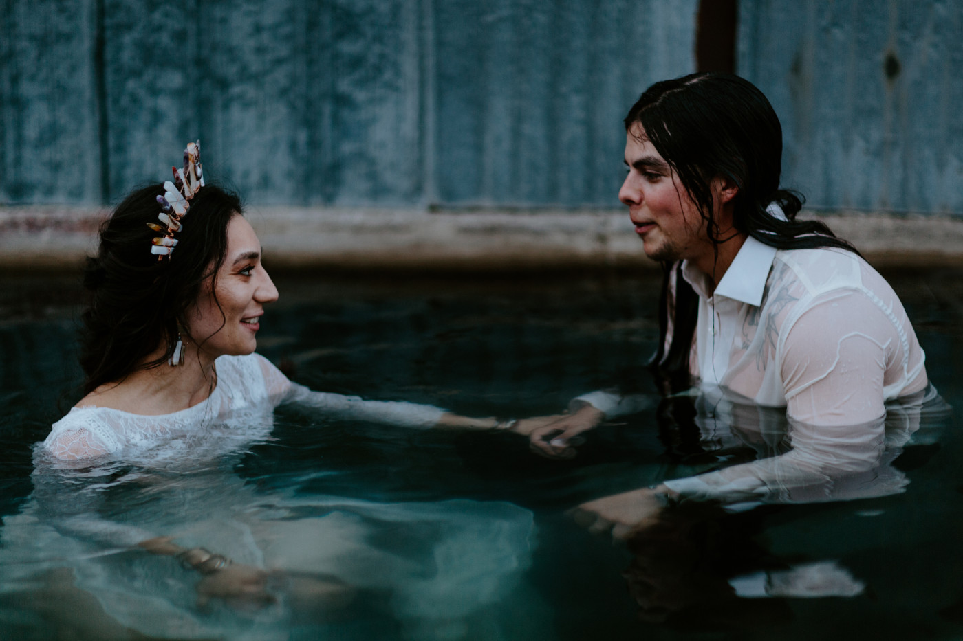 Cameron and Emerald jump into the hot springs with their clothes on.