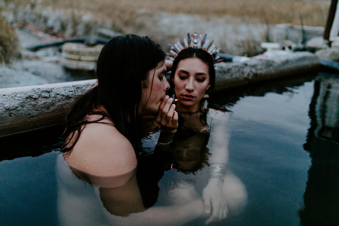 Cameron and Emerald share a joint in the hot springs.