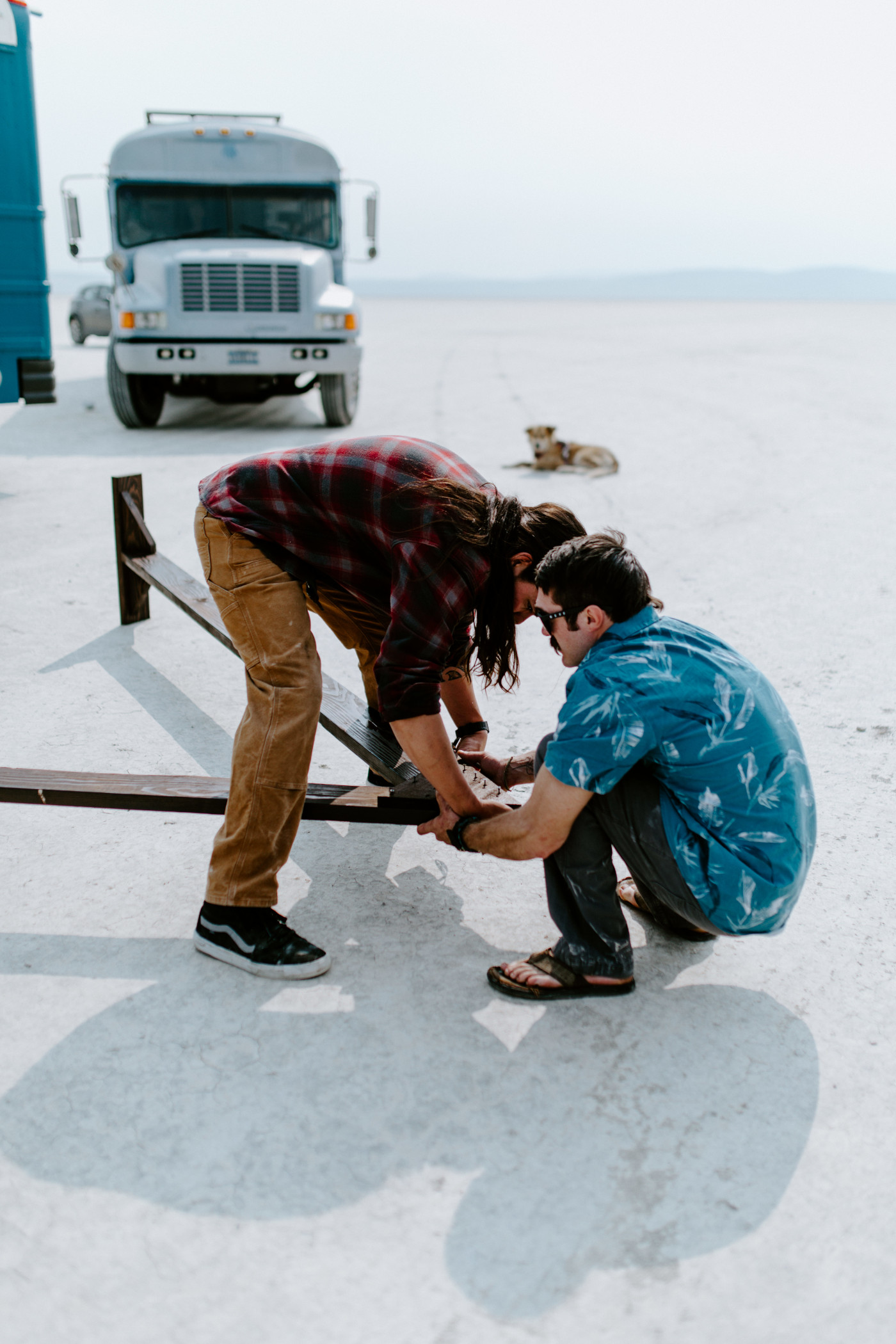 Cameron and his friend assemble the A frame altar for the elopement ceremony in the Alvord Desert.