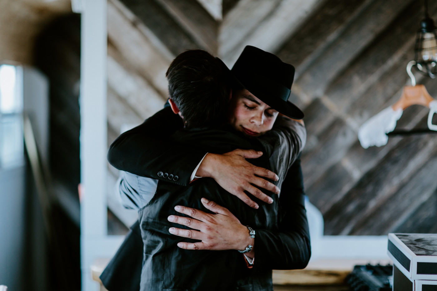 Cameron and his friend hug.