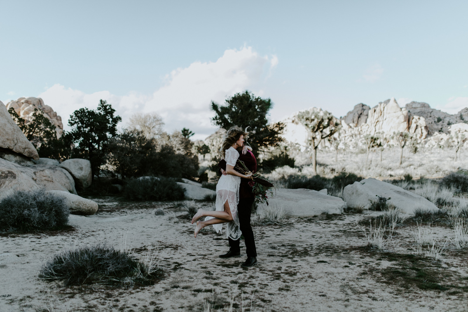 Jeremy and Alyssa hug at Joshua Tree National Park at Joshua Tree National Park, CA Elopement wedding photography at Joshua Tree National Park by Sienna Plus Josh.