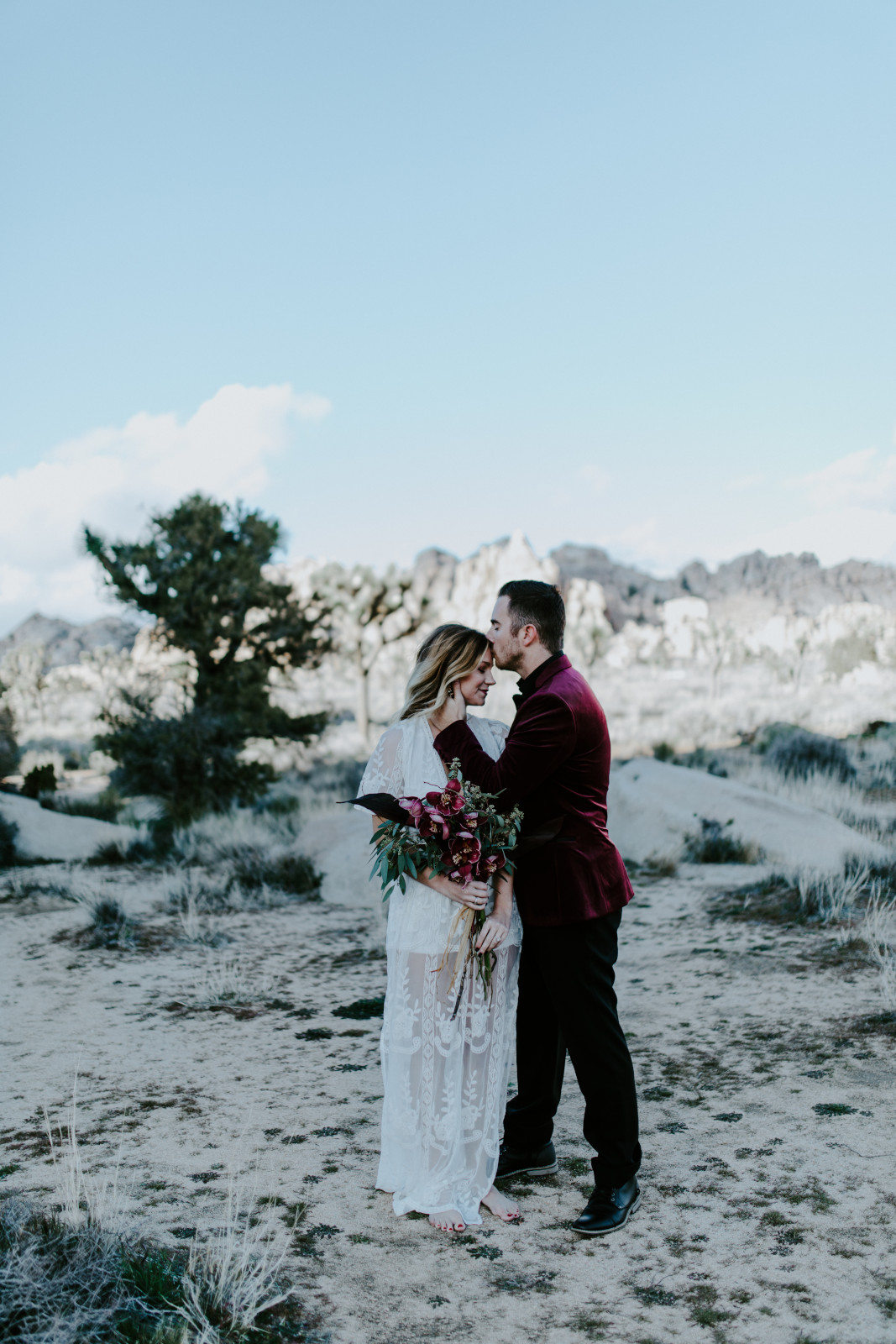 Alyssa and Jeremy face each other on the sand of Joshua Tree National Park Joshua Tree National Park, CA Elopement wedding photography at Joshua Tree National Park by Sienna Plus Josh.
