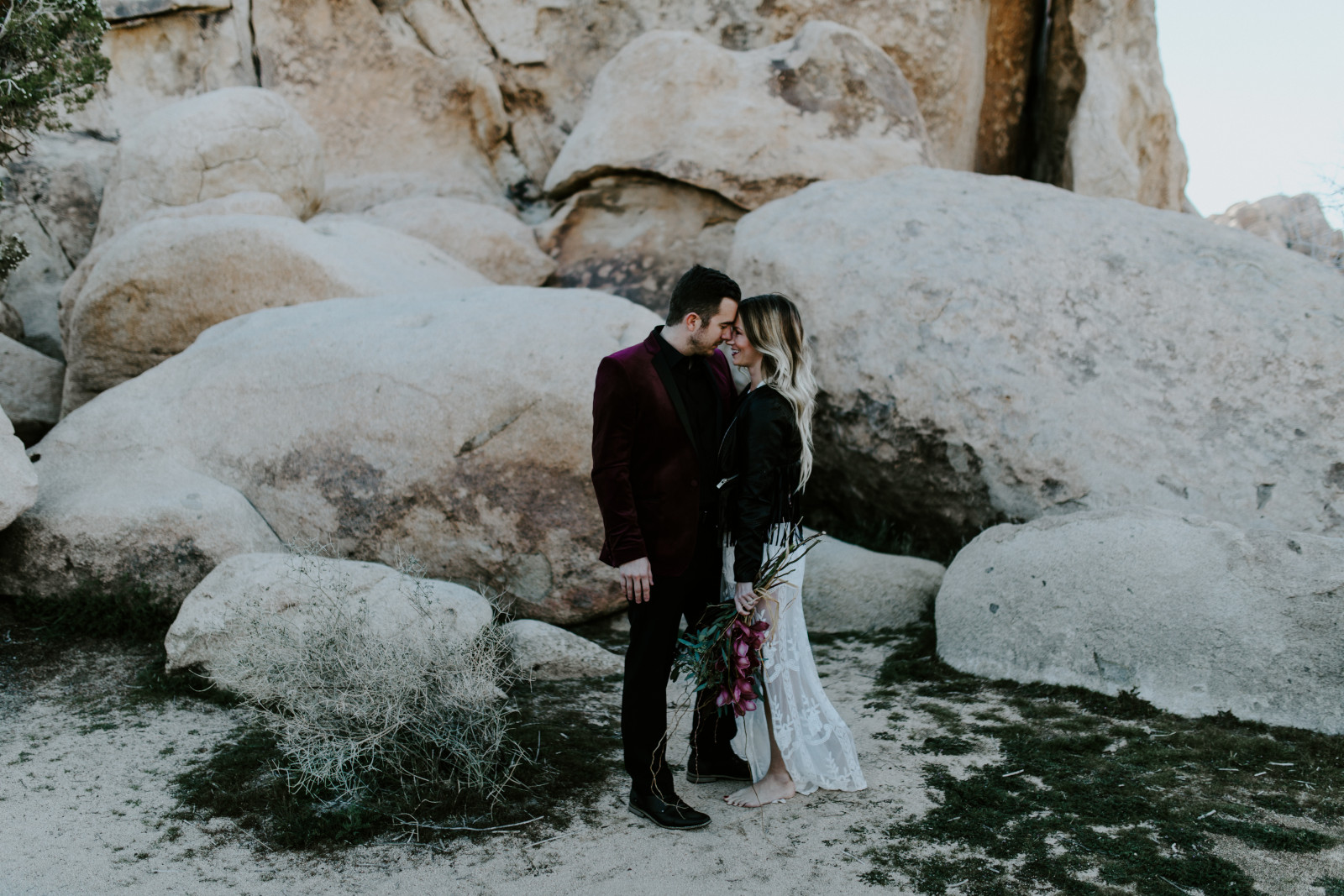 Jeremy and Alyssa stand forehead to forehead at Joshua Tree National Park, CA Elopement wedding photography at Joshua Tree National Park by Sienna Plus Josh.