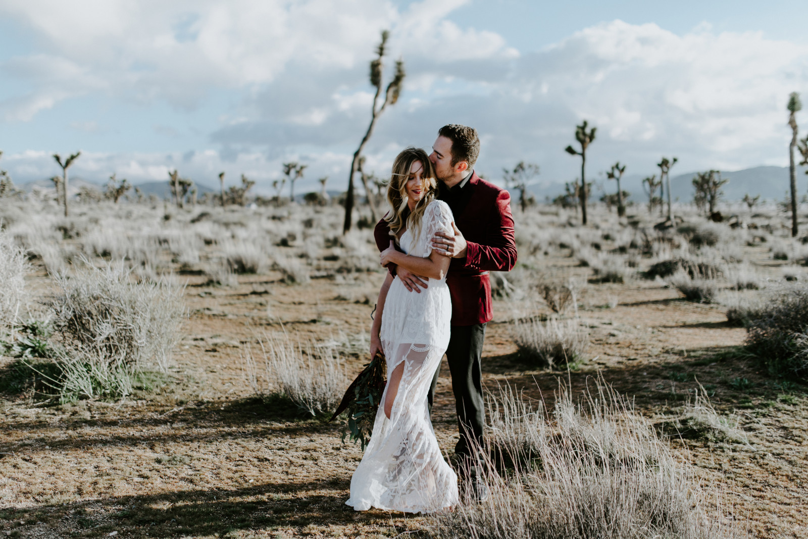 Jeremy dips Alyssa. Elopement wedding photography at Joshua Tree National Park by Sienna Plus Josh.