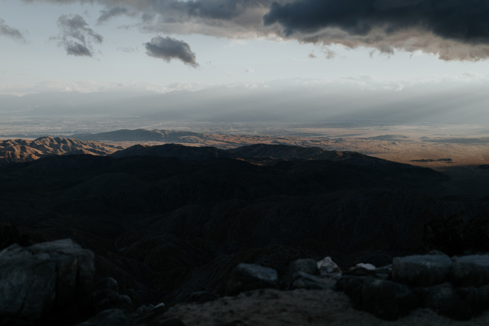 Jeremy holds Alyssa with a view of Joshua Tree National Park. Elopement wedding photography at Joshua Tree National Park by Sienna Plus Josh.