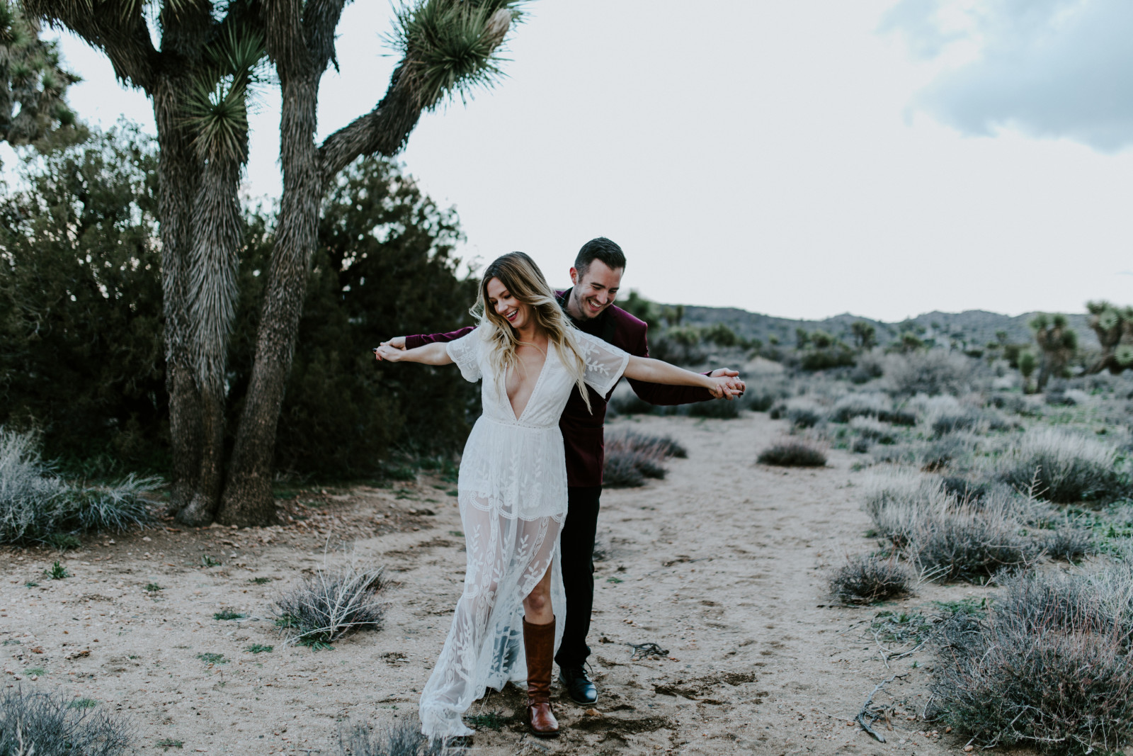 Alyssa sits with Jeremy at Joshua Tree National Park, CA Elopement wedding photography at Joshua Tree National Park by Sienna Plus Josh.