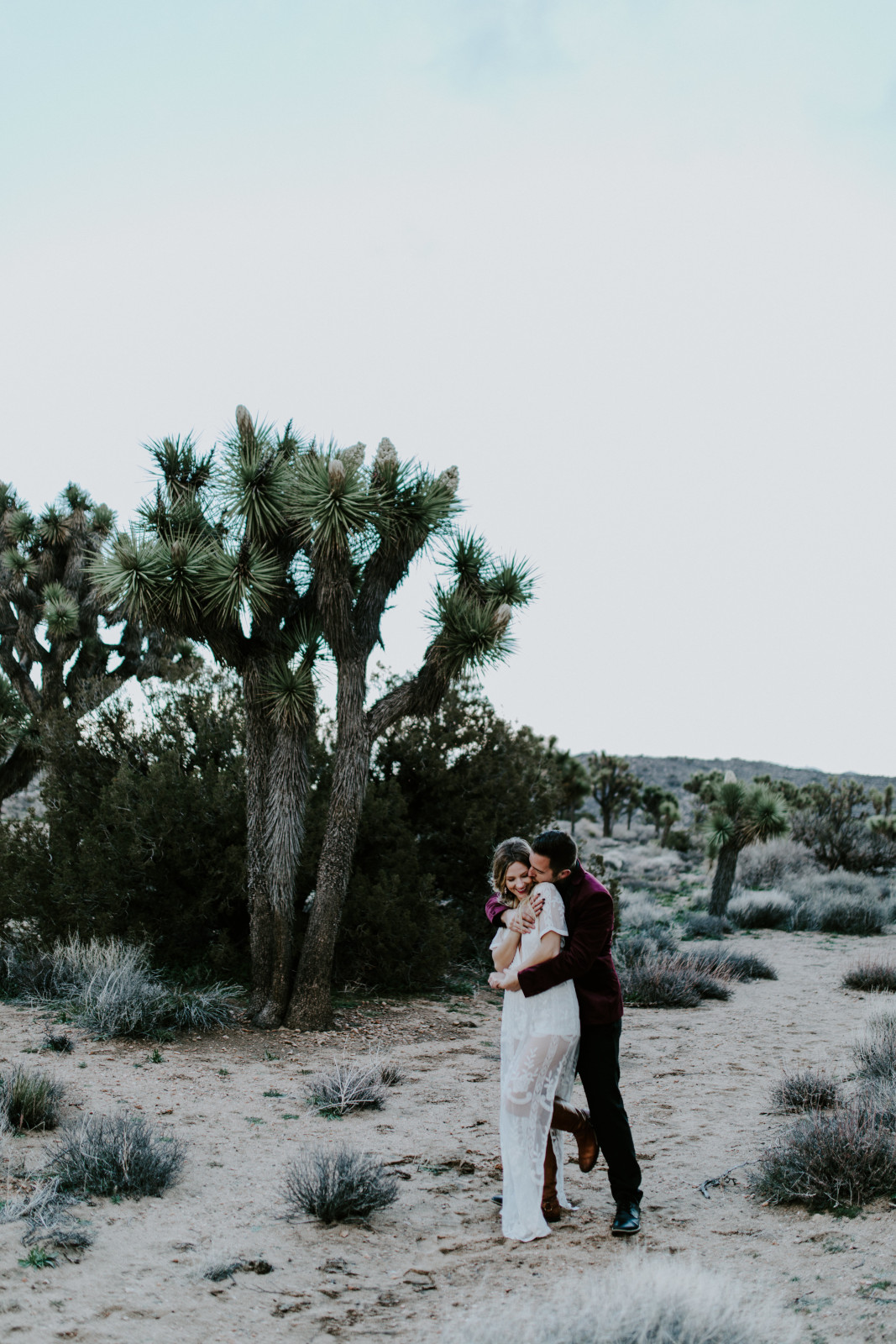 Jeremy holds Alyssa at Joshua Tree National Park, CA Elopement wedding photography at Joshua Tree National Park by Sienna Plus Josh.