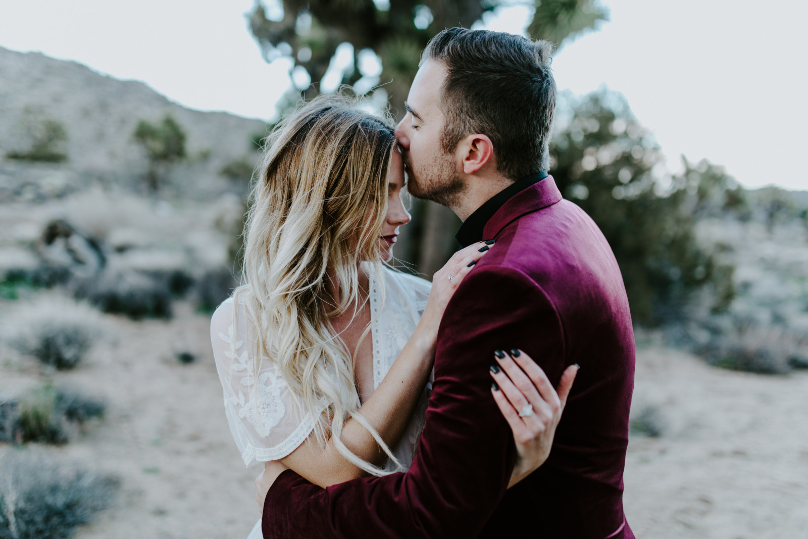 Jeremy and Alyssa lay in the sand at Joshua Tree National Park, CA Elopement wedding photography at Joshua Tree National Park by Sienna Plus Josh.