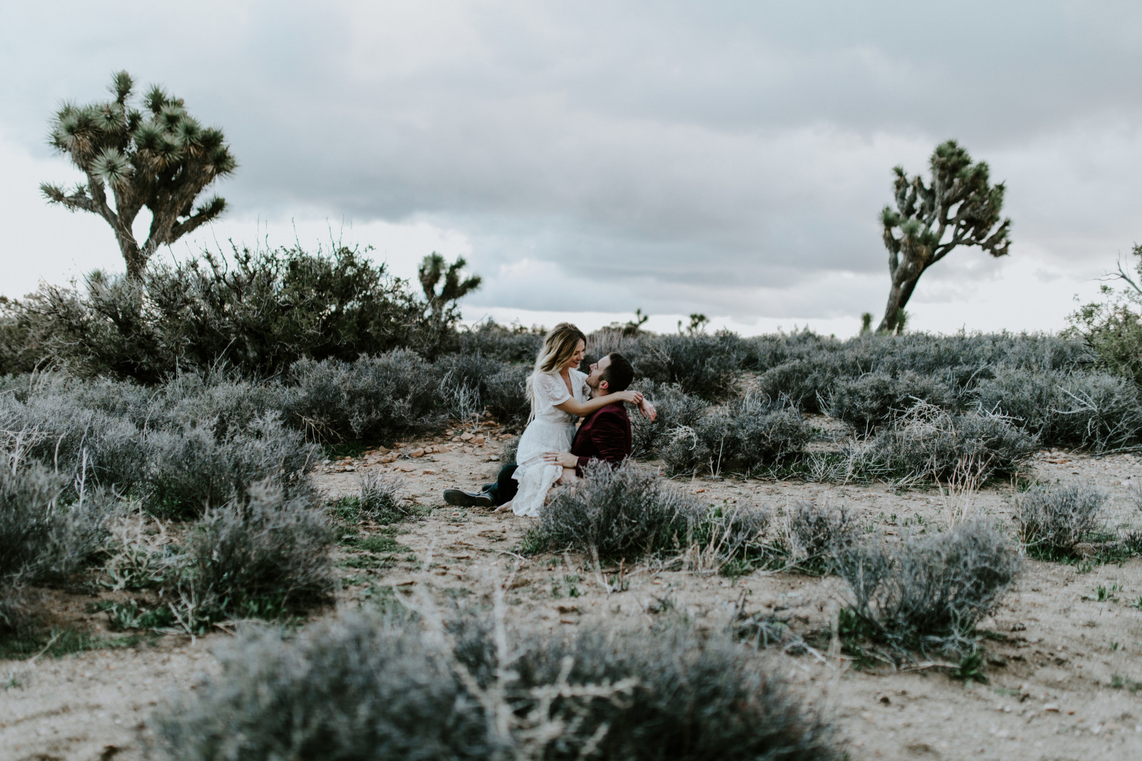 Alyssa and Jeremy share a moment at Joshua Tree. Elopement wedding photography at Joshua Tree National Park by Sienna Plus Josh.