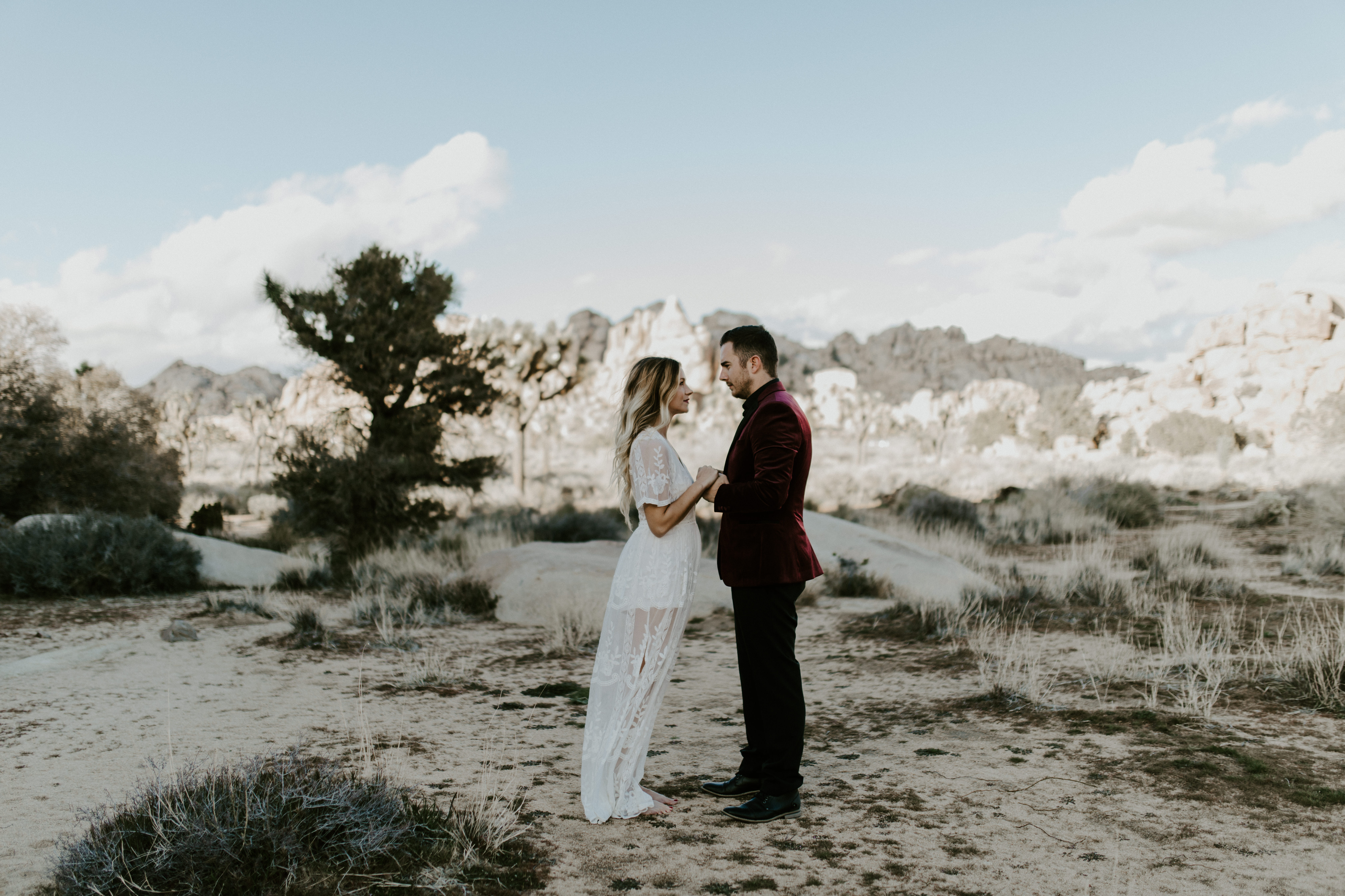 A couple runs down a path after their elopement.