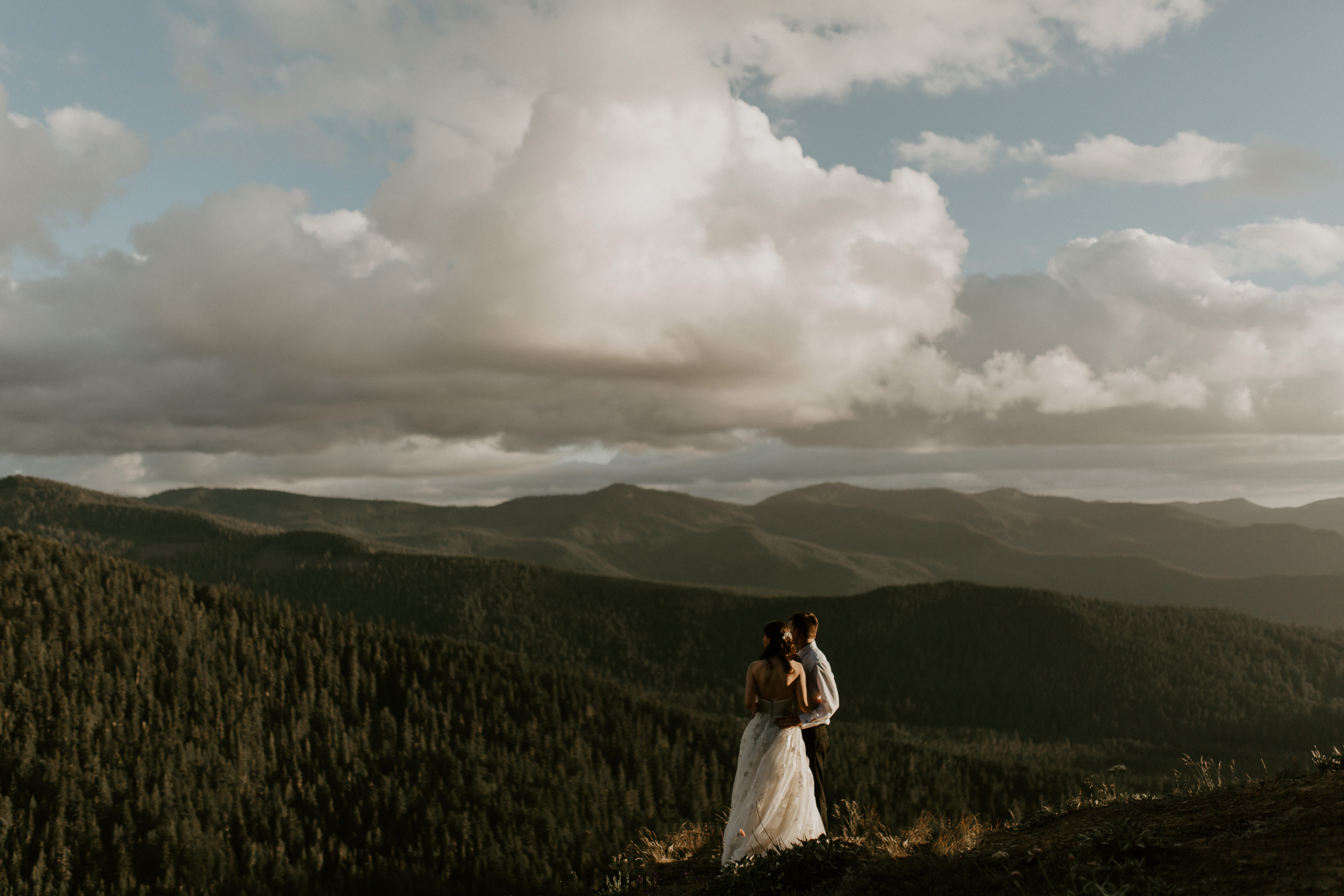 A couple runs down a path after their elopement.