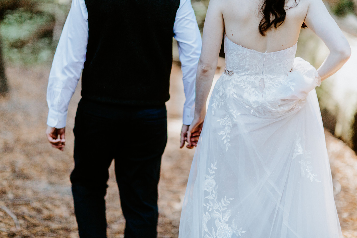 Hannah and Tim walk hand in hand.