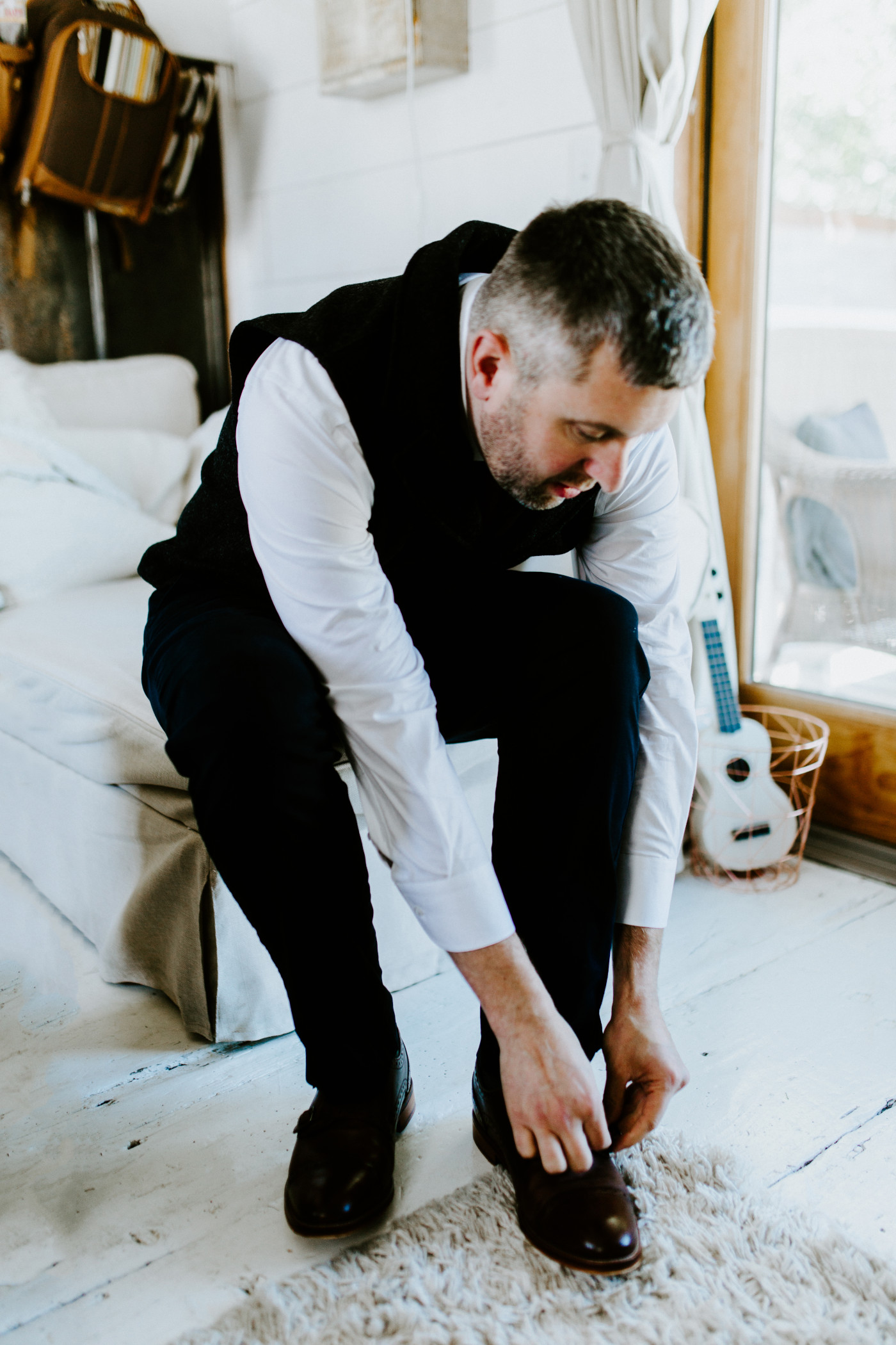 Tim puts on his shoes for his elopement.