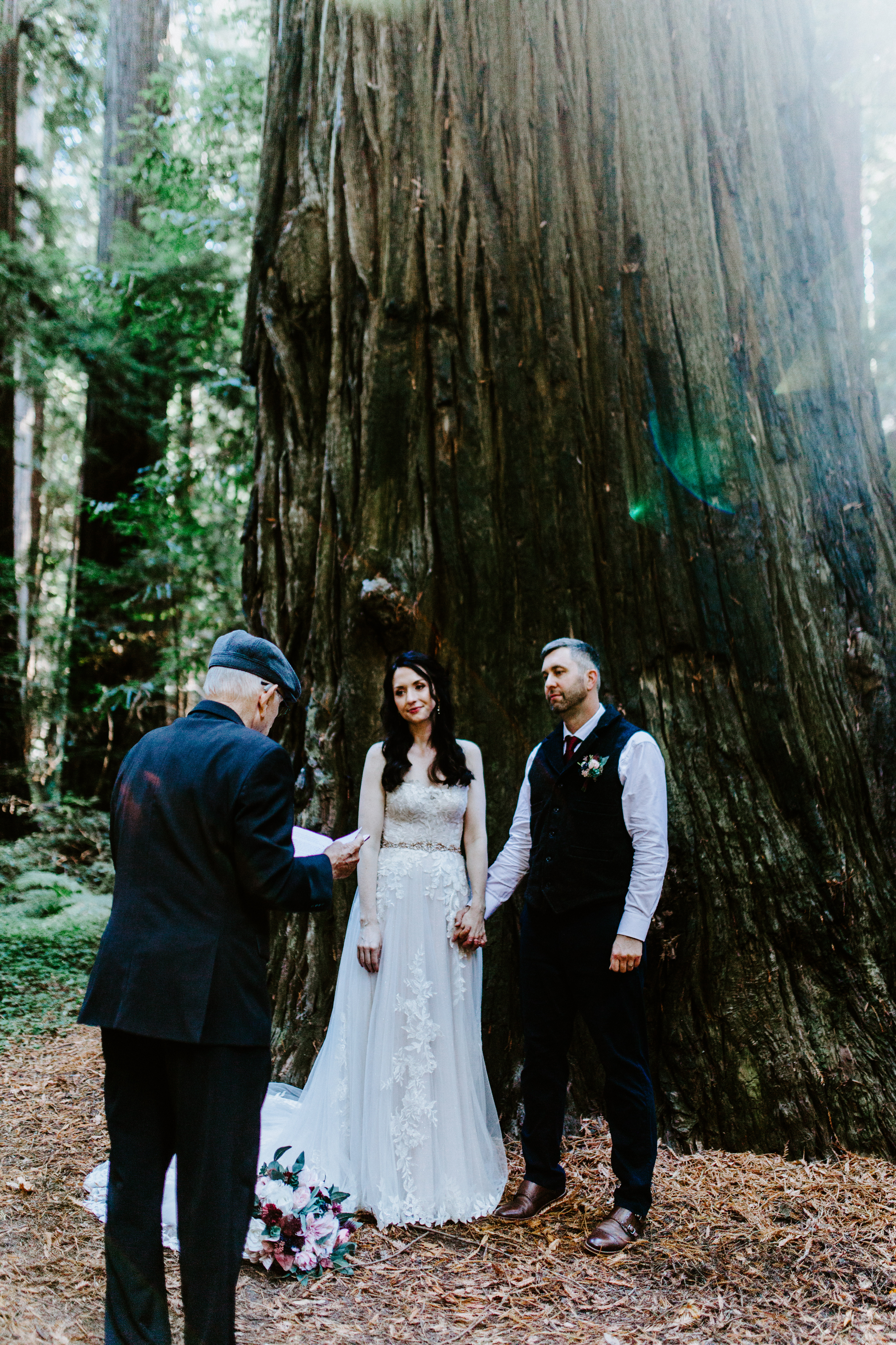 Hannah and Tim hold hands during their elopement ceremony.