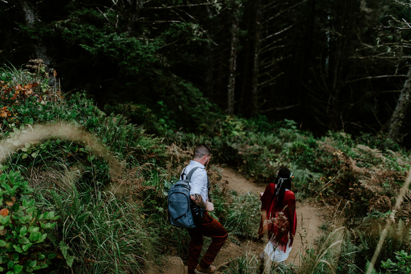 Allison and TJ hike down to their elopement ceremony spot in Ecola State Park.