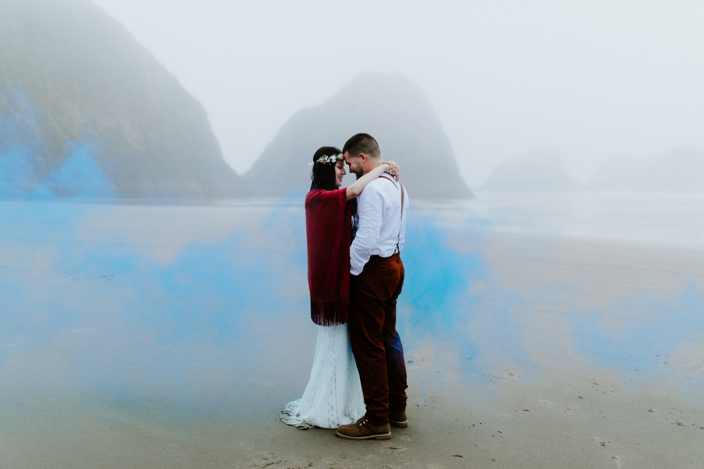 TJ and Allison stand forehead to forehead on the beach.