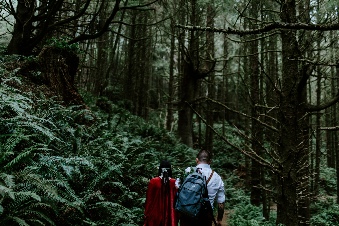 TJ and Allison hike together in the woods in Cannon Beach, OR.
