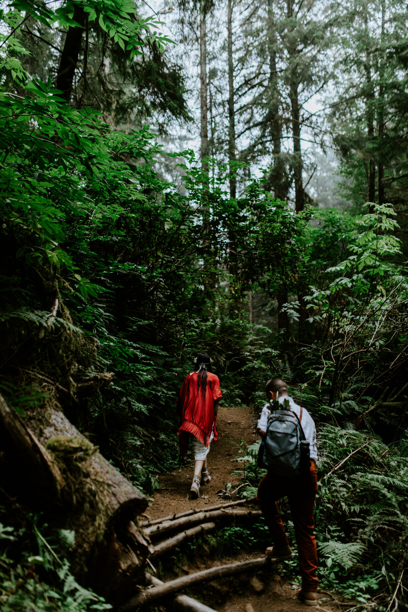 Allison and TJ walk together through the woods in Ecola State Park.
