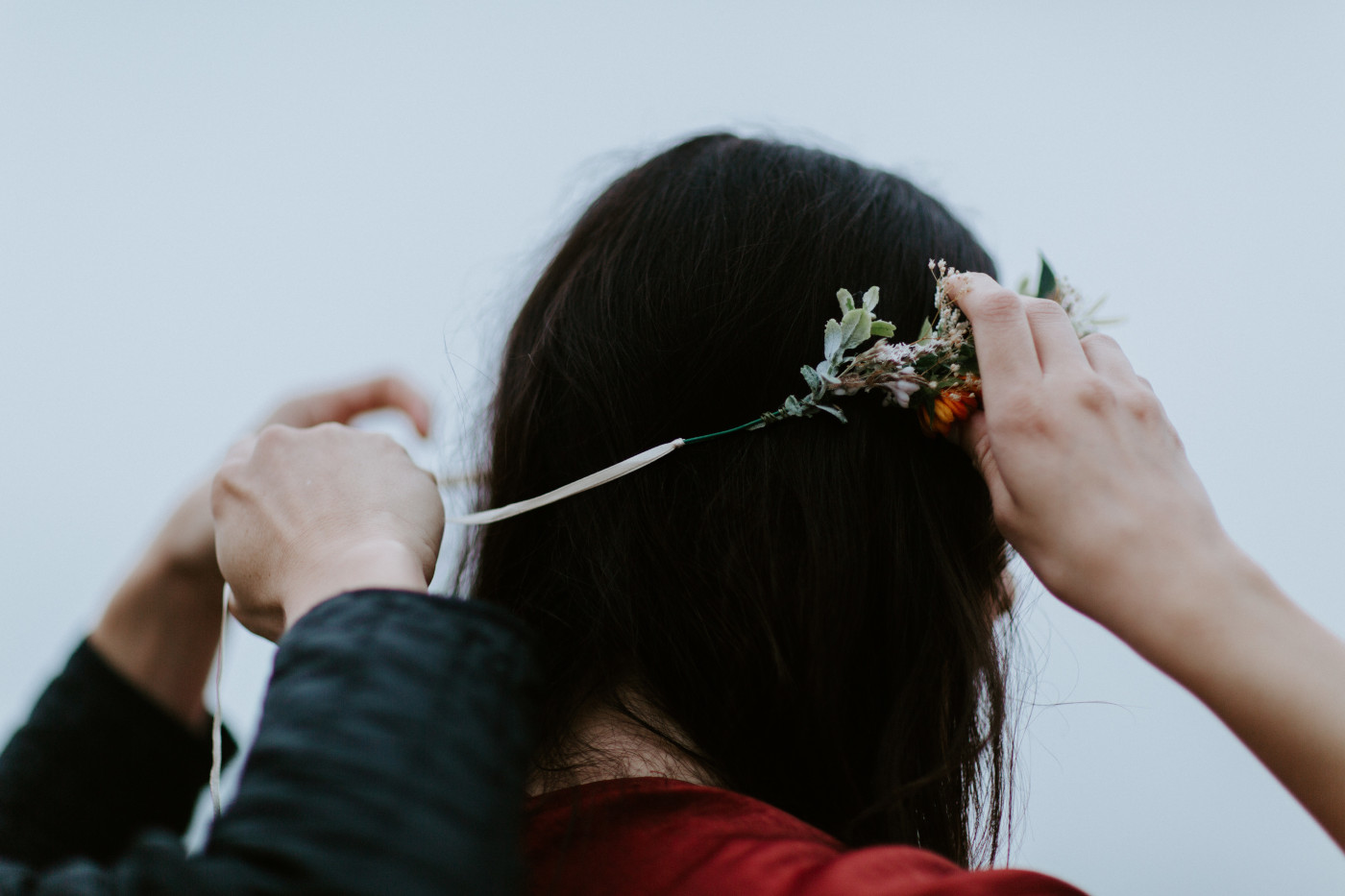 Allison gets her flower crown tied on for her elopement.