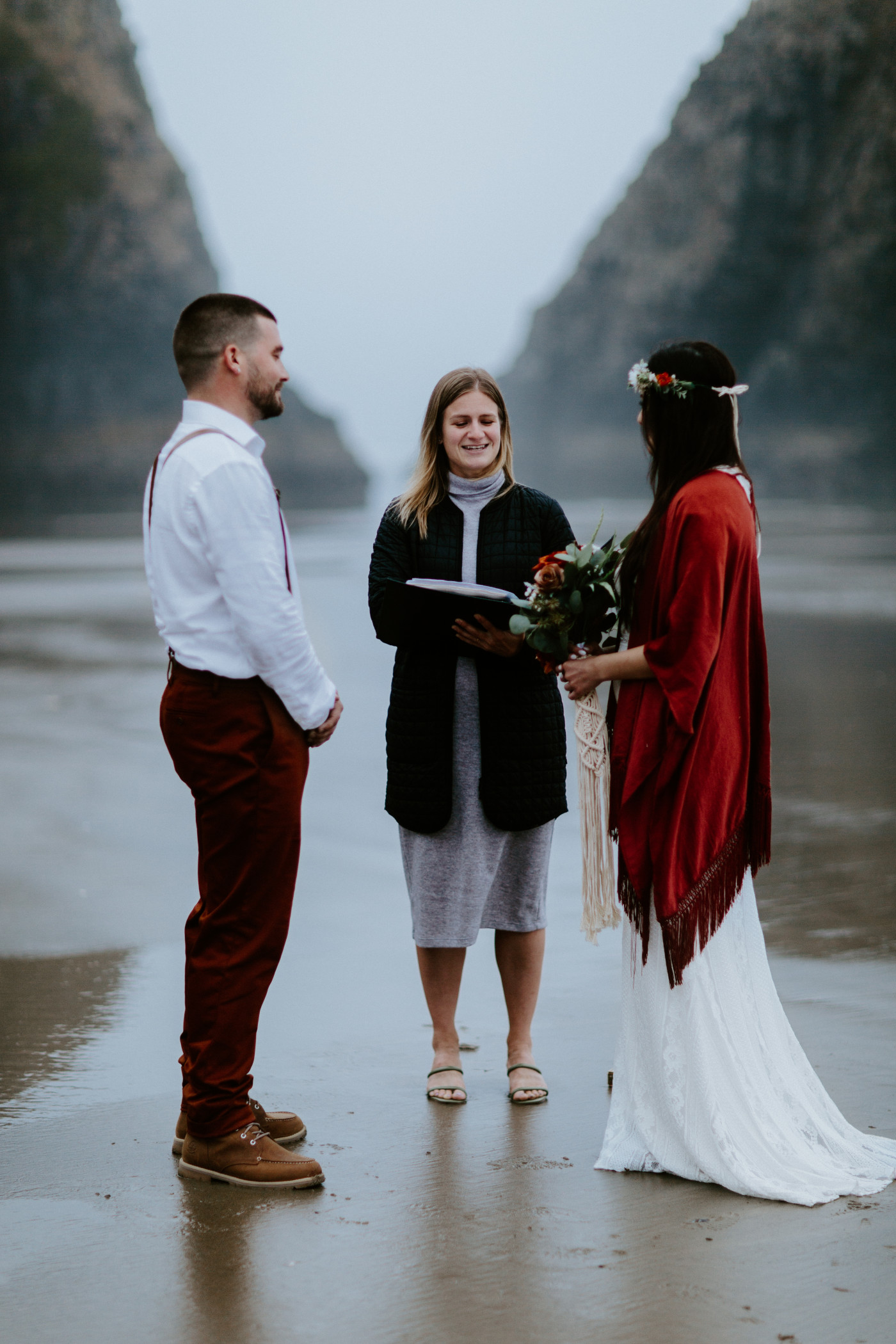 Allison and TJ listen as their officiant reads during their elopement ceremony at Ecola State Park.