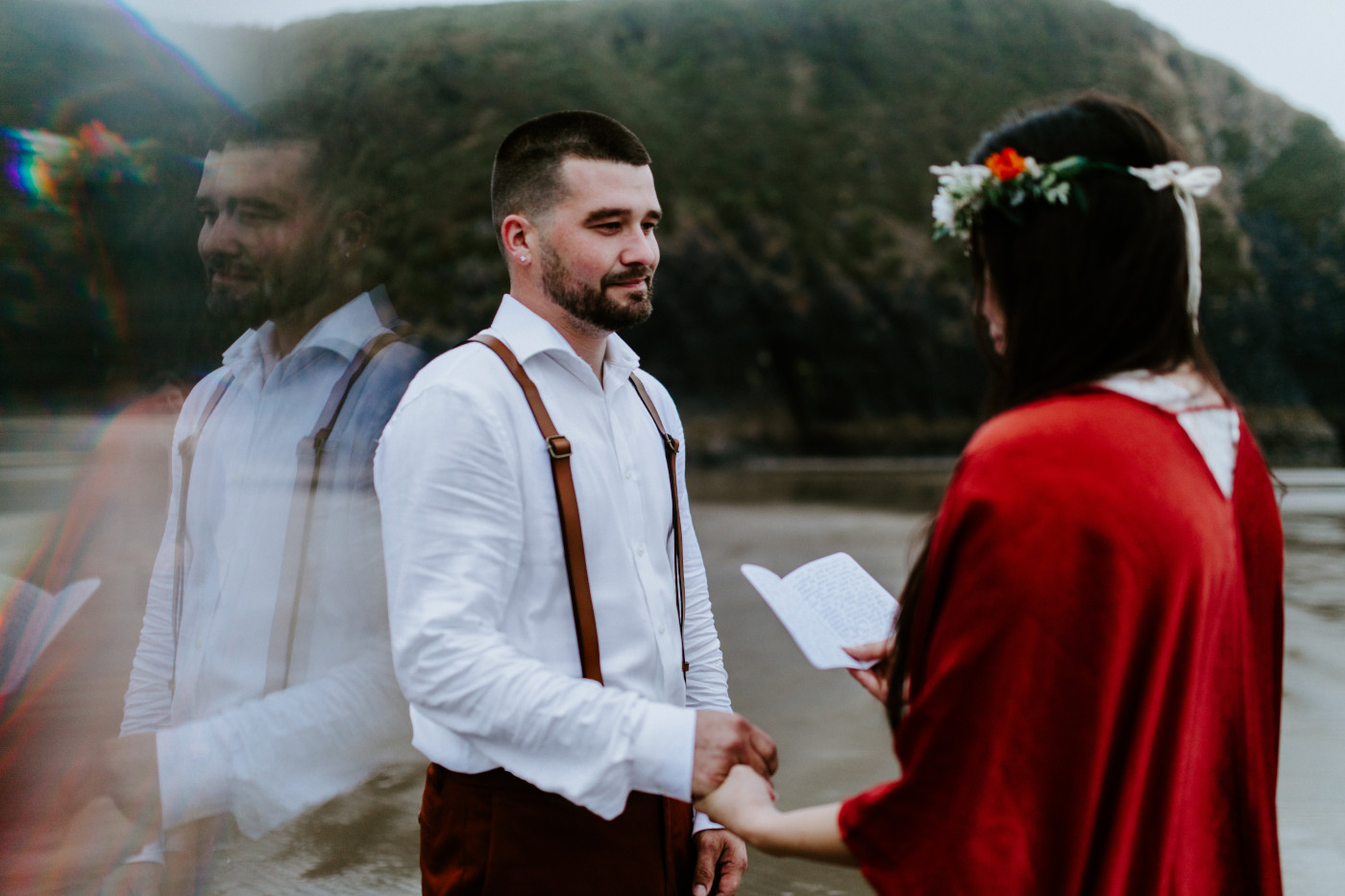 TJ holds Allison's hand as she reads her vows.