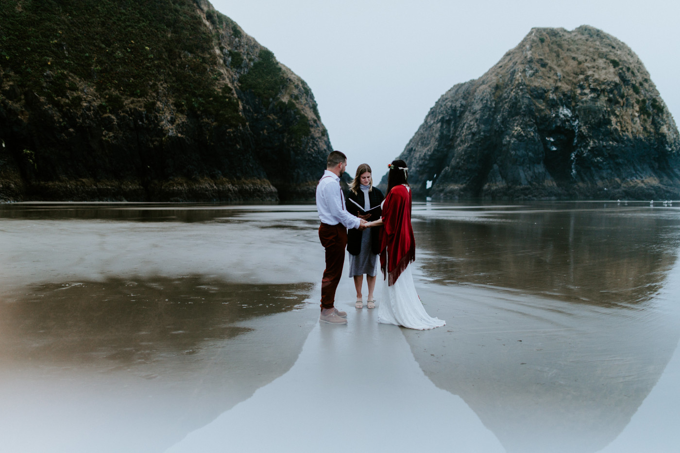Allison and TJ finalize their elopement ceremony on the beach.