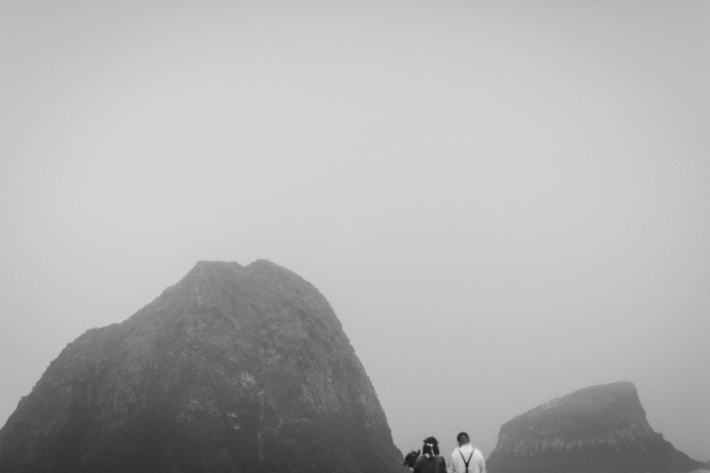 Allison and TJ walk toward the rocks on Cannon Beach.