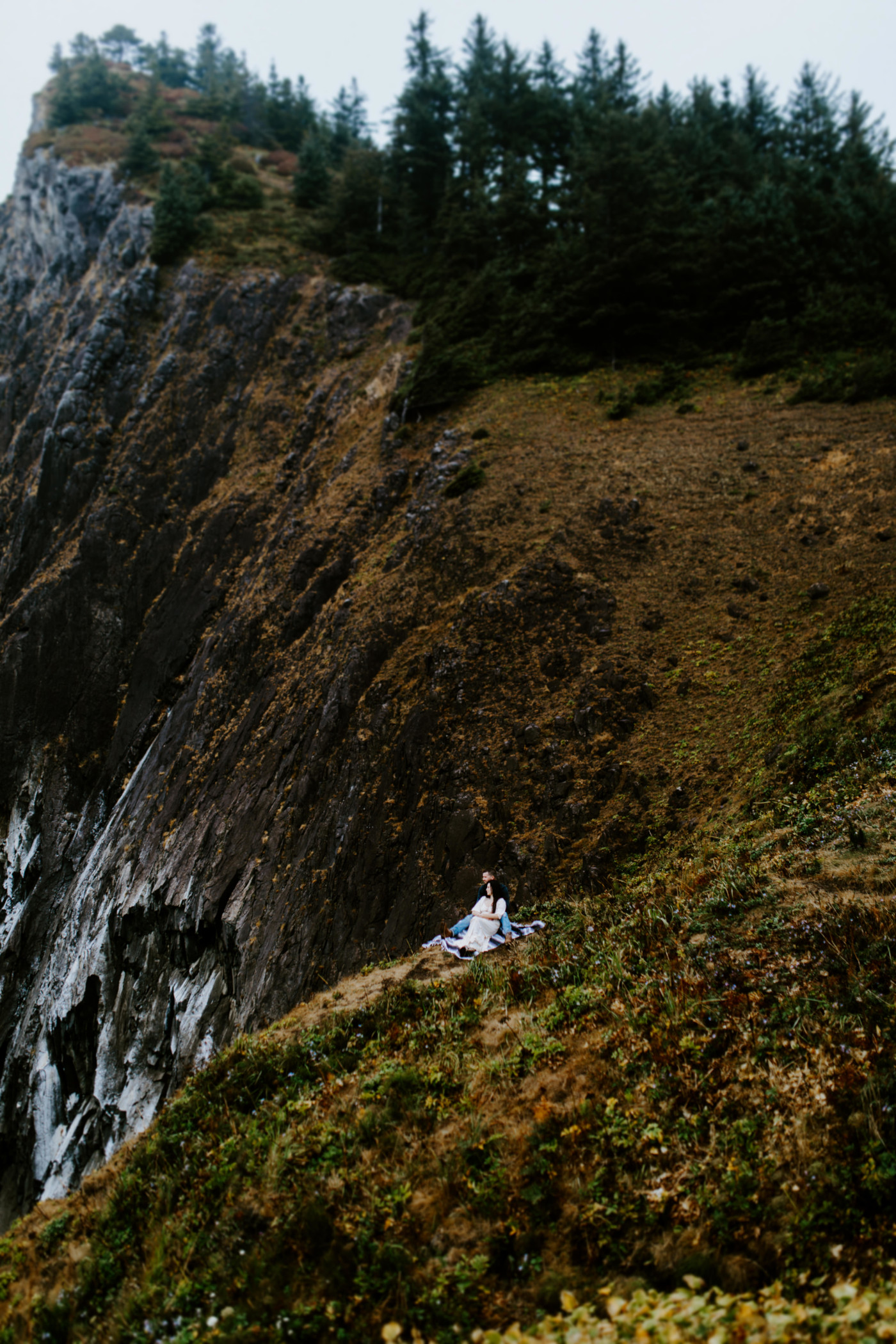 Allison and TJ sitting on the cliff edge.