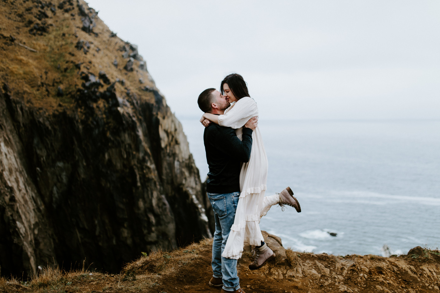 TJ lifts Allison up into the air to kiss her.