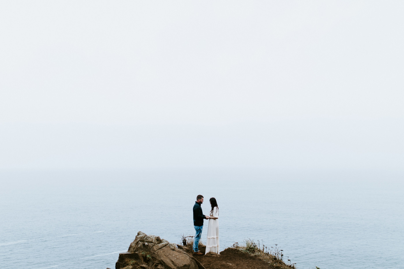 Allison and TJ stand near a cliff.