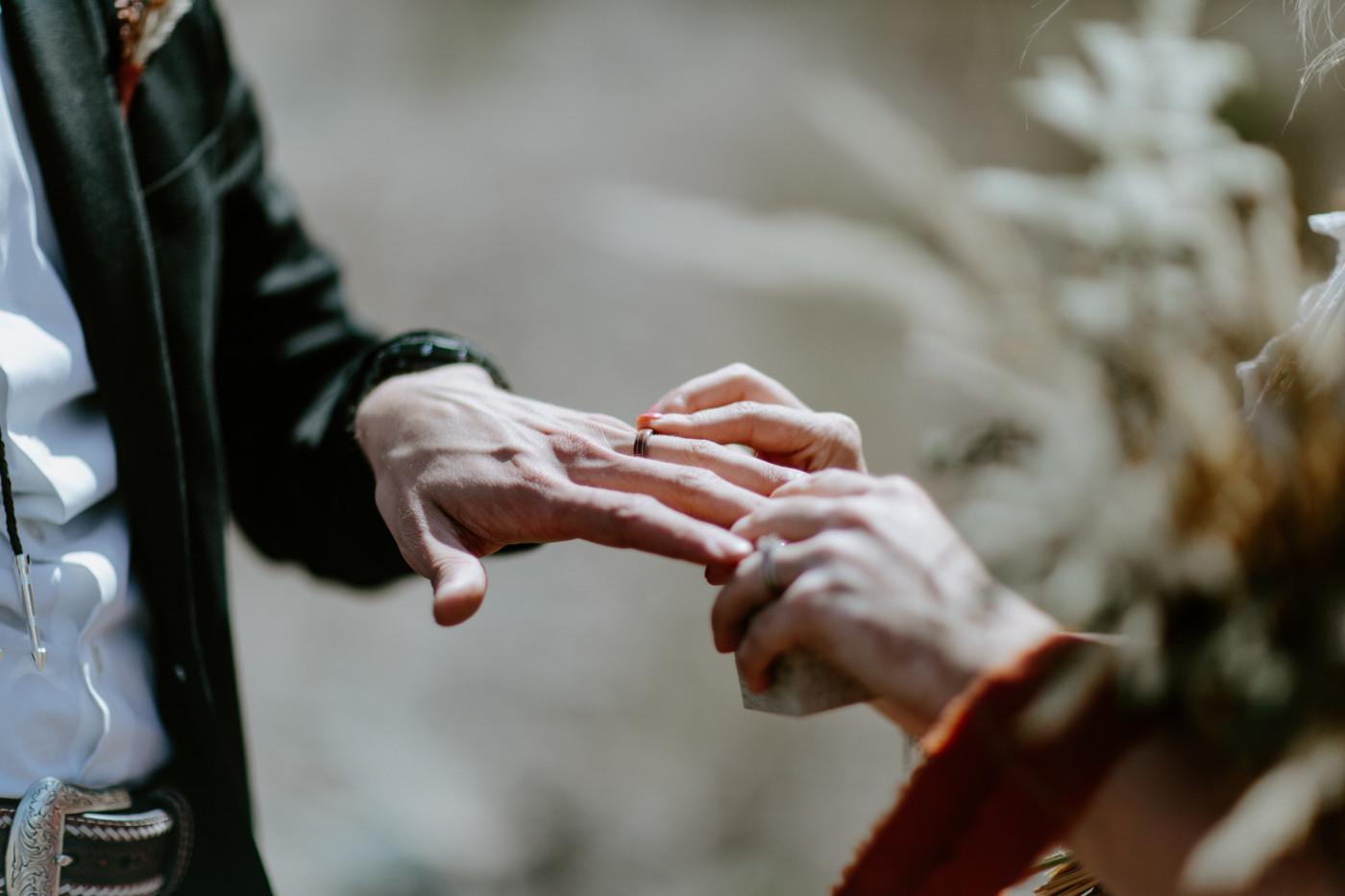 Greyson and Emily finalizing the ceremony. Elopement photography in the Central Oregon desert by Sienna Plus Josh.