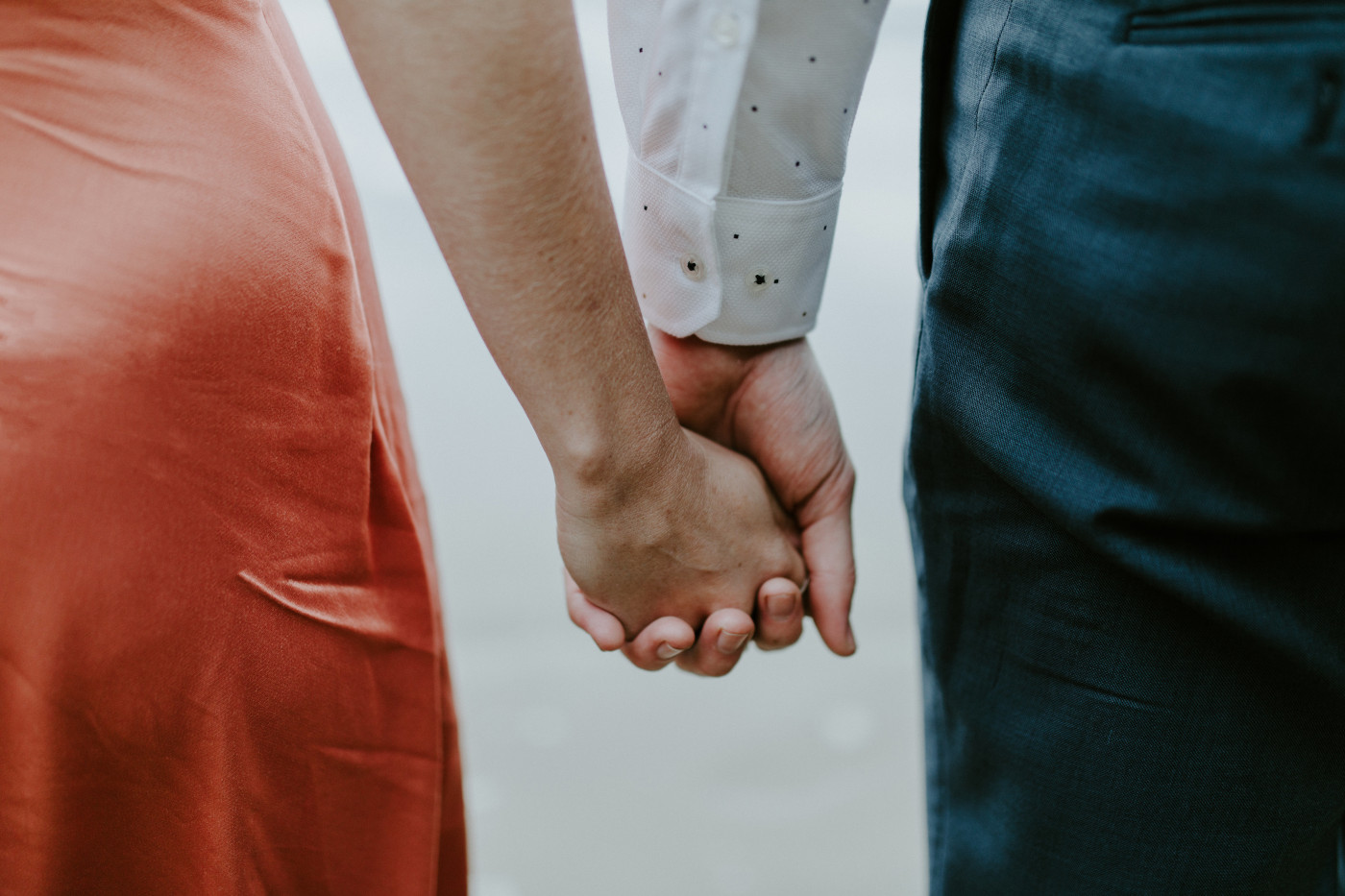 Chelsey and Billy hold hands. Elopement wedding photography at Cannon Beach by Sienna Plus Josh.