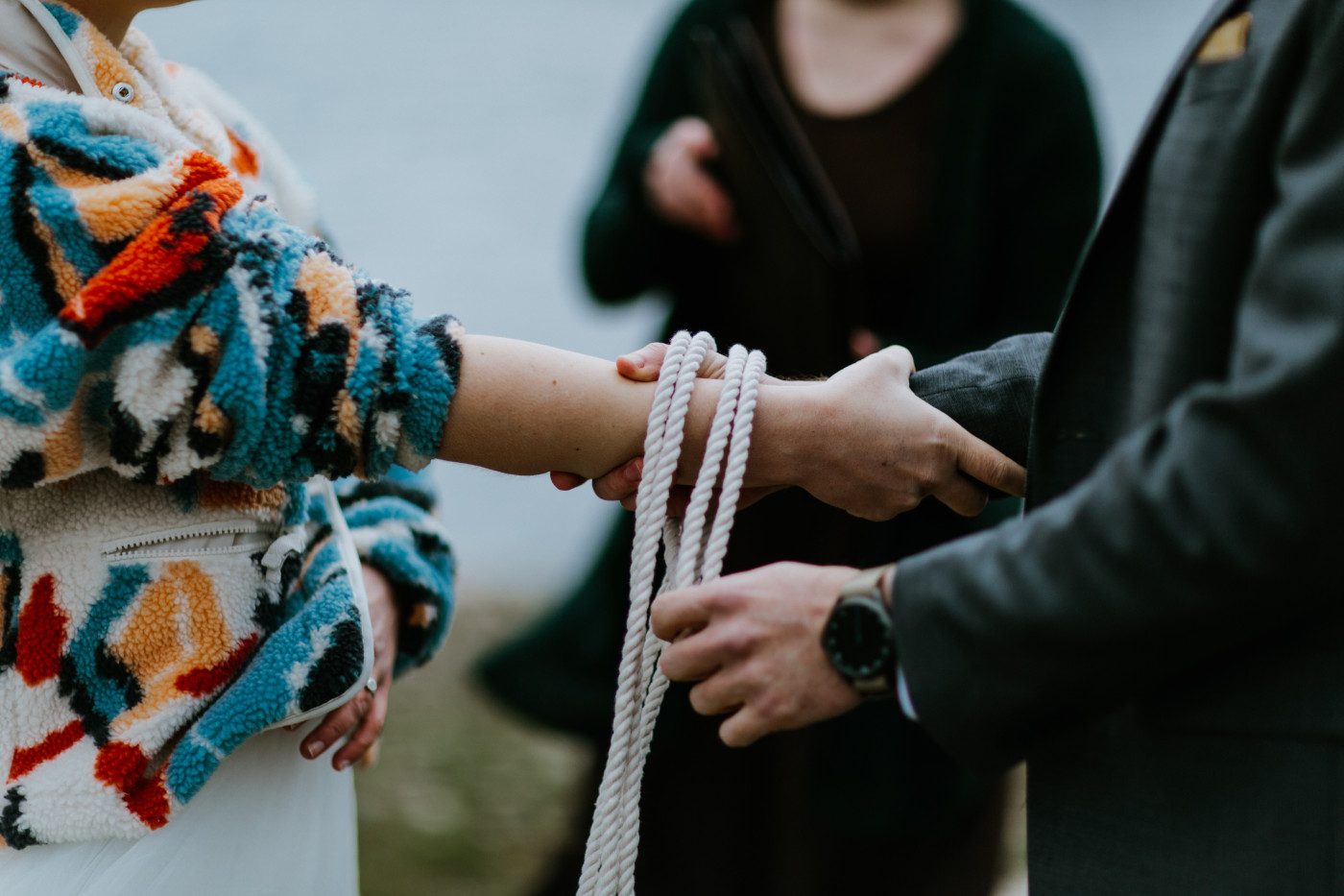 Allison and Lennie tying their hands. Elopement photography at Columbia River Gorge by Sienna Plus Josh.