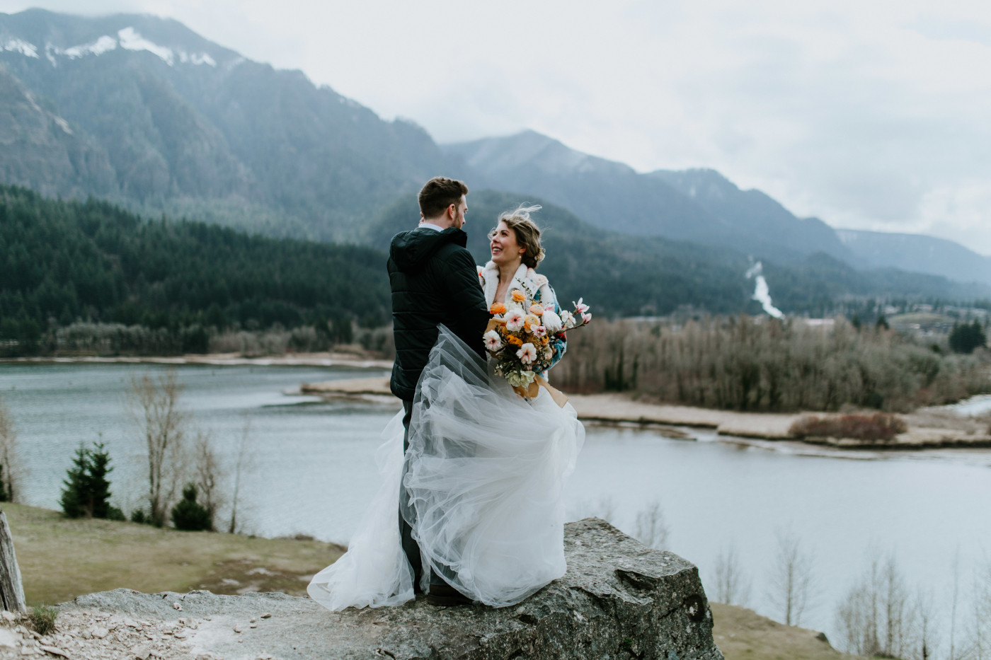 Allison and Lennie stand near a windy cliff. Elopement photography at Columbia River Gorge by Sienna Plus Josh.