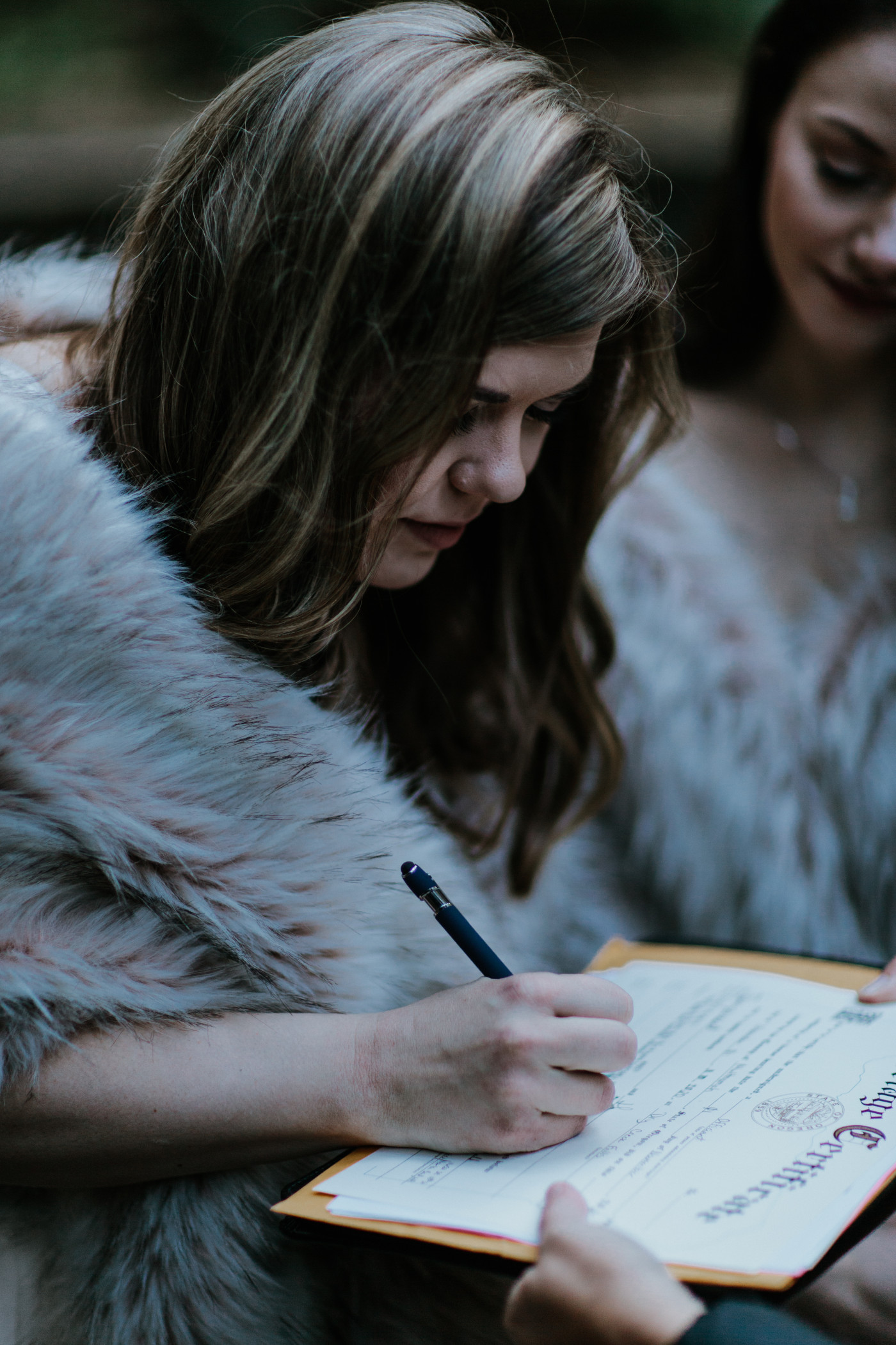 Hayley signs the marriage license. Elopement photography at the Columbia River Gorge by Sienna Plus Josh.