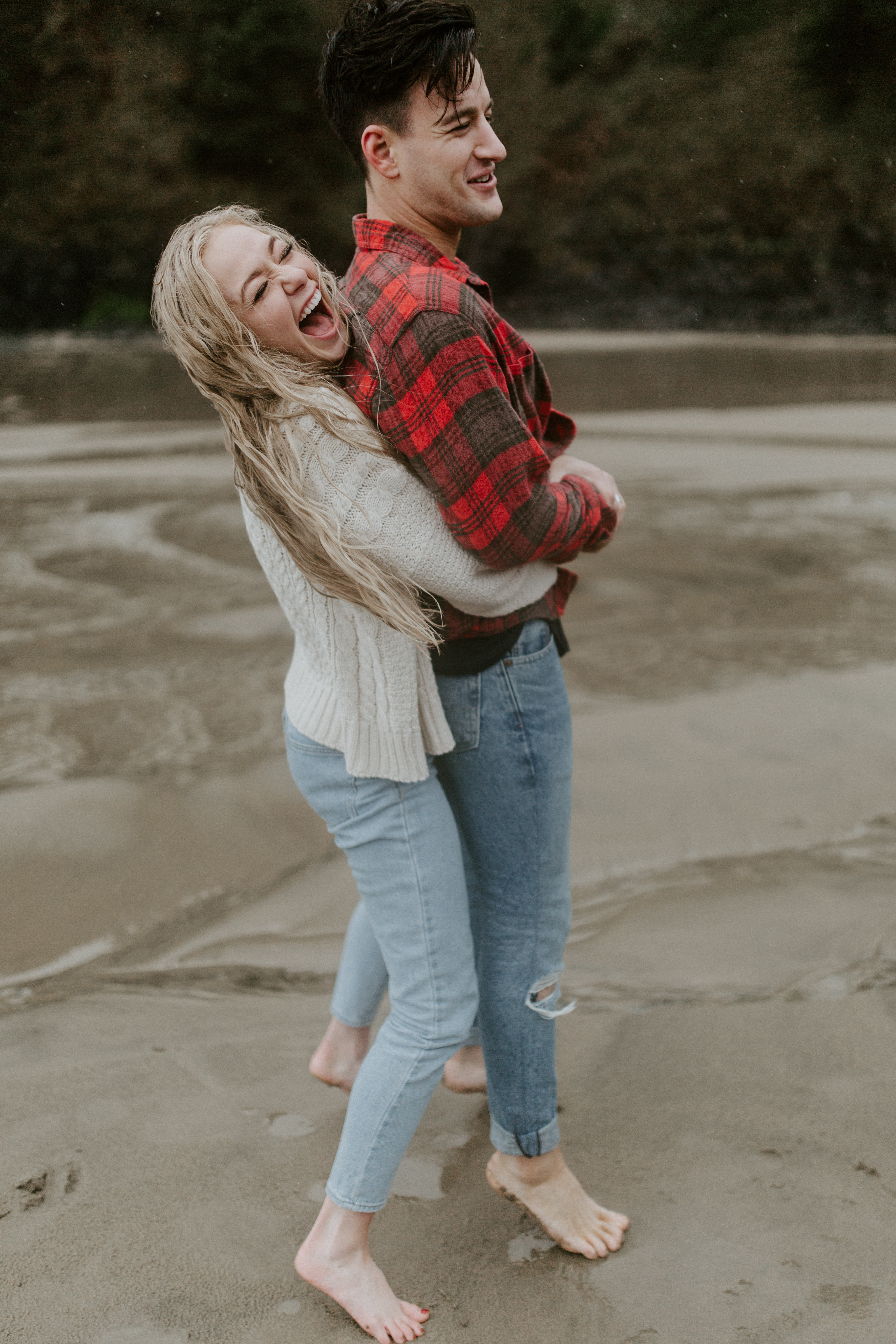 Hannah and Grant walk along the sand on Indian Beach in Ecola State Park, Oregon. Engagement photography in Oregon by Sienna Plus Josh.