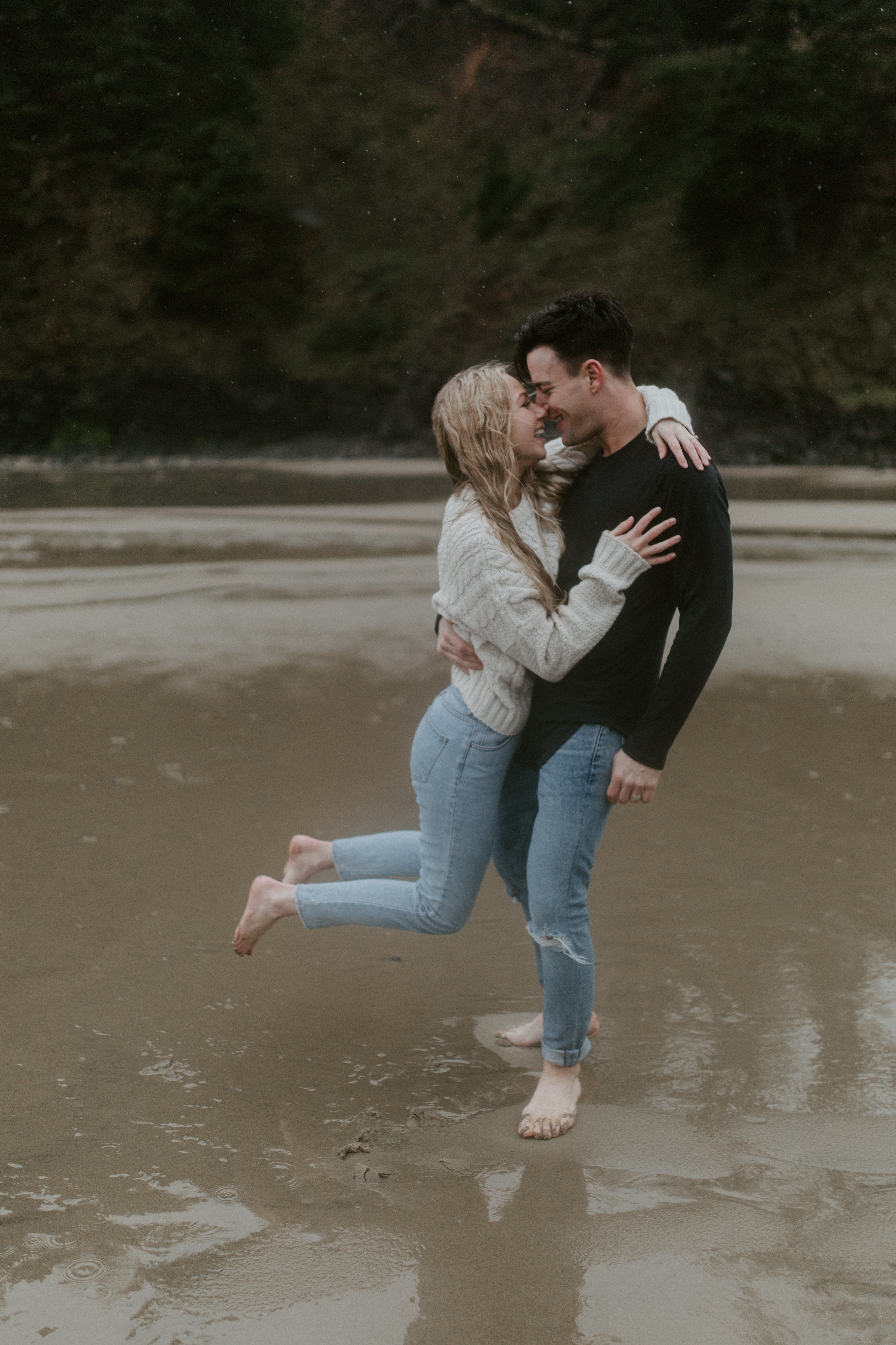 Grant lifts Hannah on Indian Beach in Ecola State Park, Oregon. Engagement photography in Oregon by Sienna Plus Josh.