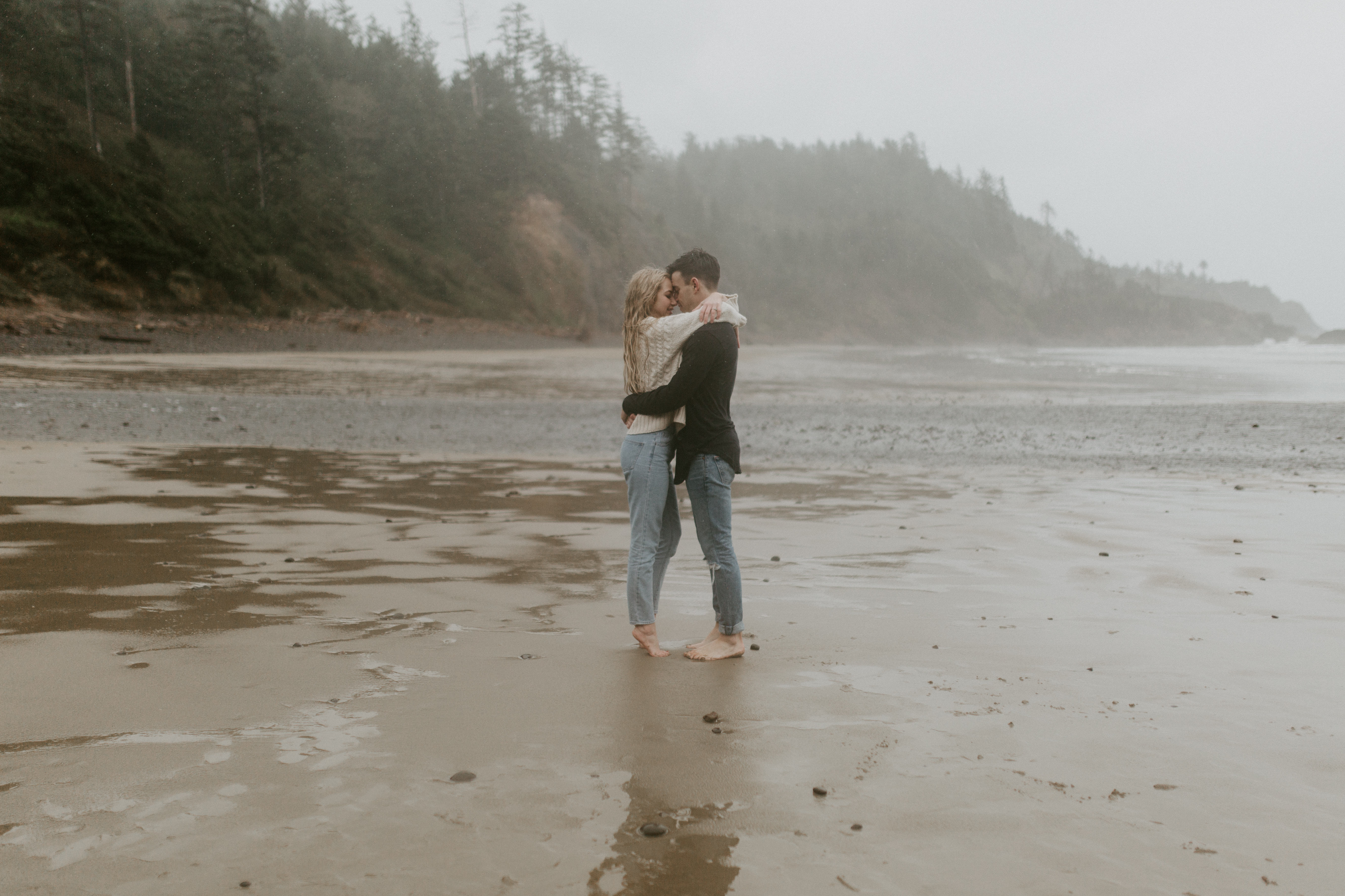 Hannah and Grant admire eachother on Indian Beach in Ecola State Park, Oregon. Engagement photography in Oregon by Sienna Plus Josh.