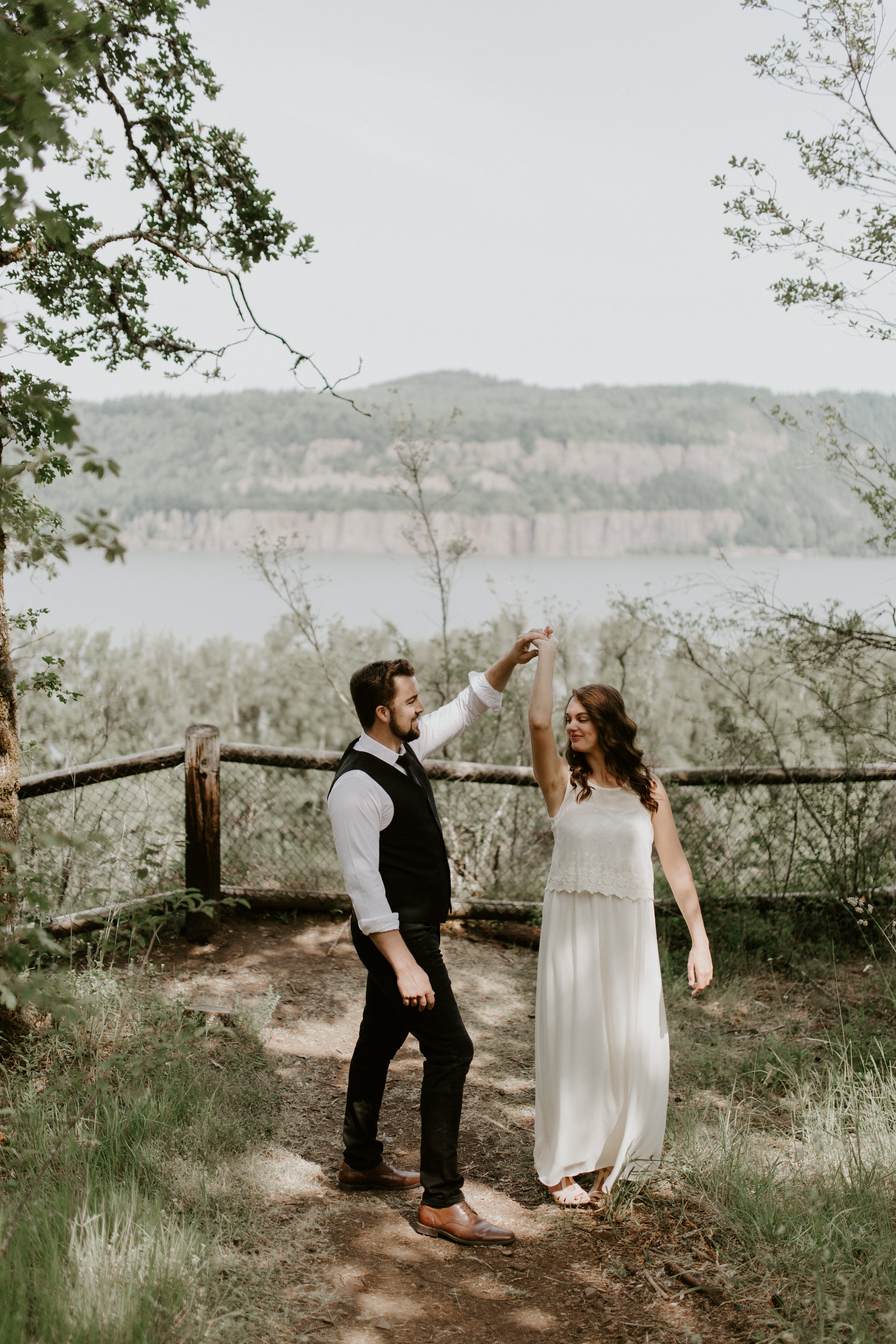 Josh twirls Emily as they dance at Bridal Veil Falls, Oregon. Elopement photography in Portland Oregon by Sienna Plus Josh.