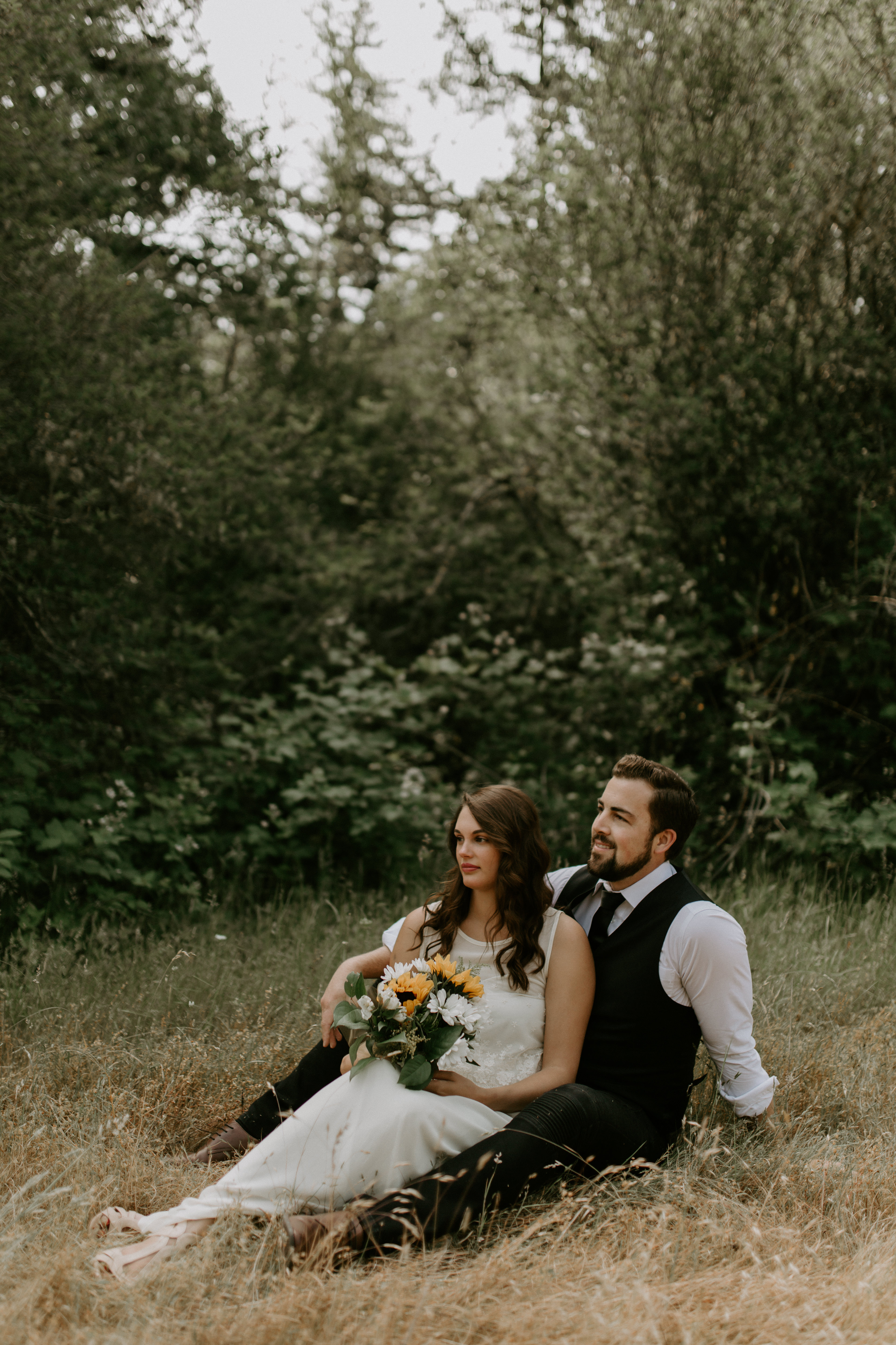 Emily sits on Josh's lap at Bridal Veil Falls in Oregon. Elopement photography in Portland Oregon by Sienna Plus Josh.