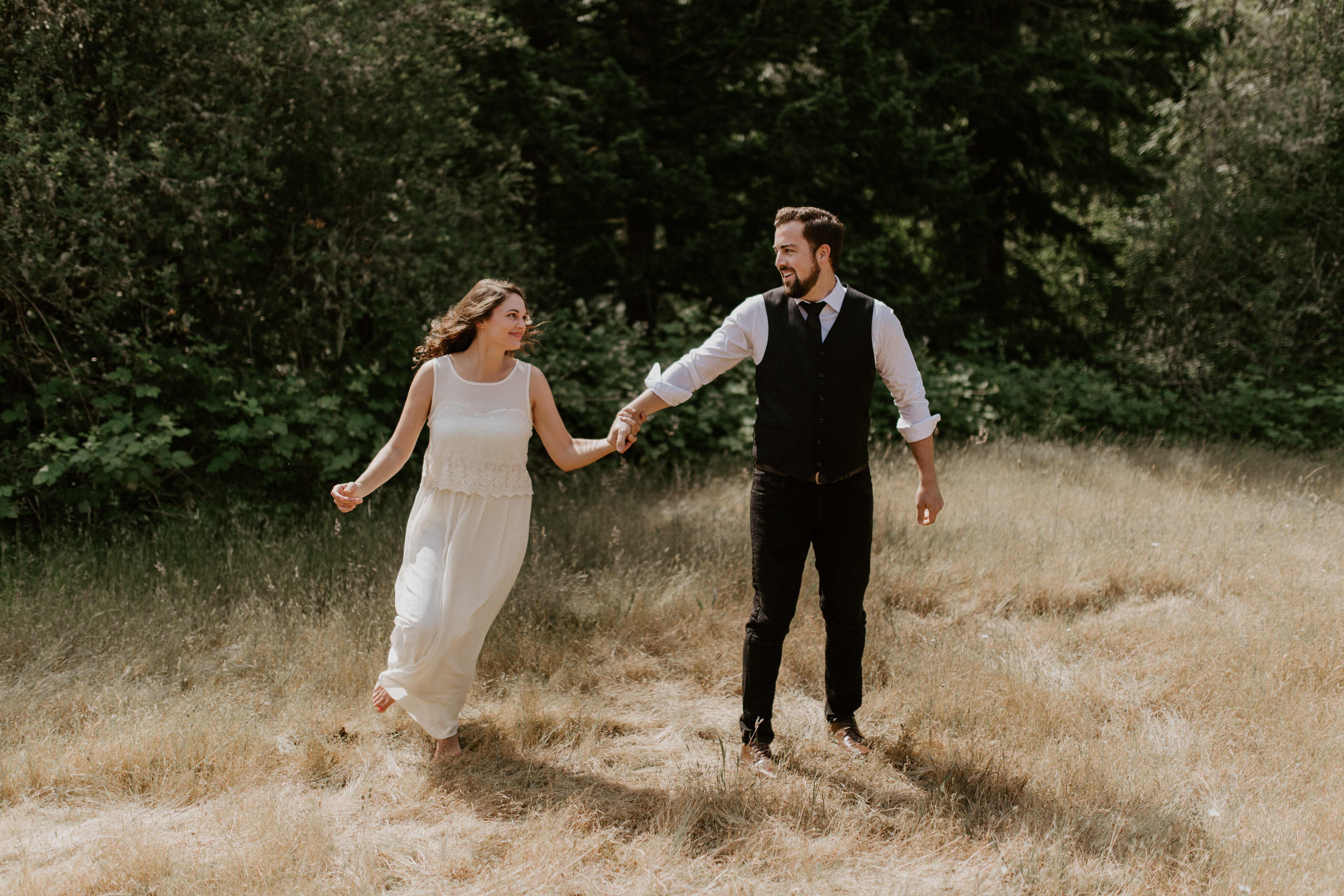 Emily runs around Josh at Bridal Veil Falls, Oregon. Elopement photography in Portland Oregon by Sienna Plus Josh.