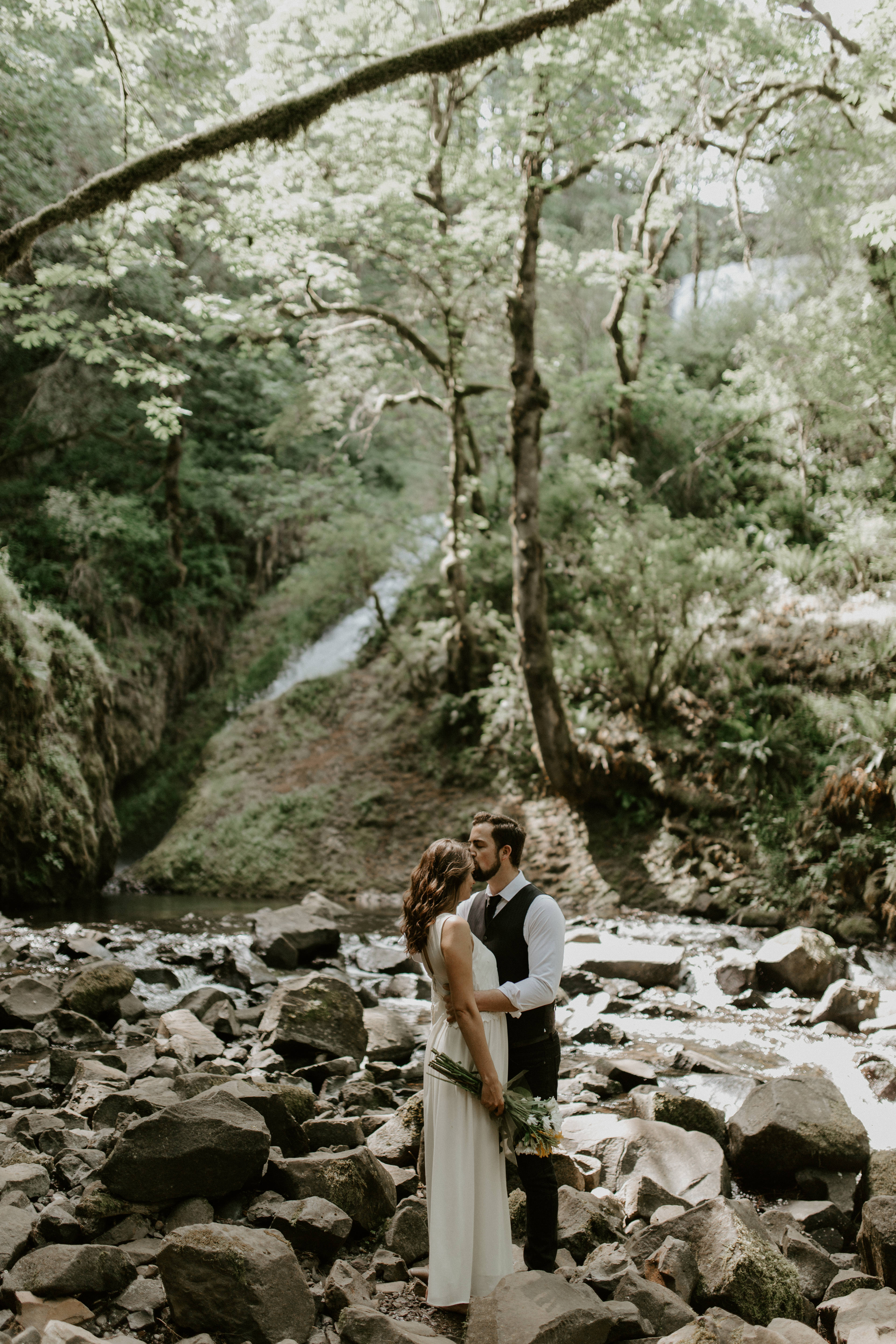 Josh kisses Emily at the Columbia River Gorge in Oregon for her Oregon elopement. Elopement photography in Portland Oregon by Sienna Plus Josh.