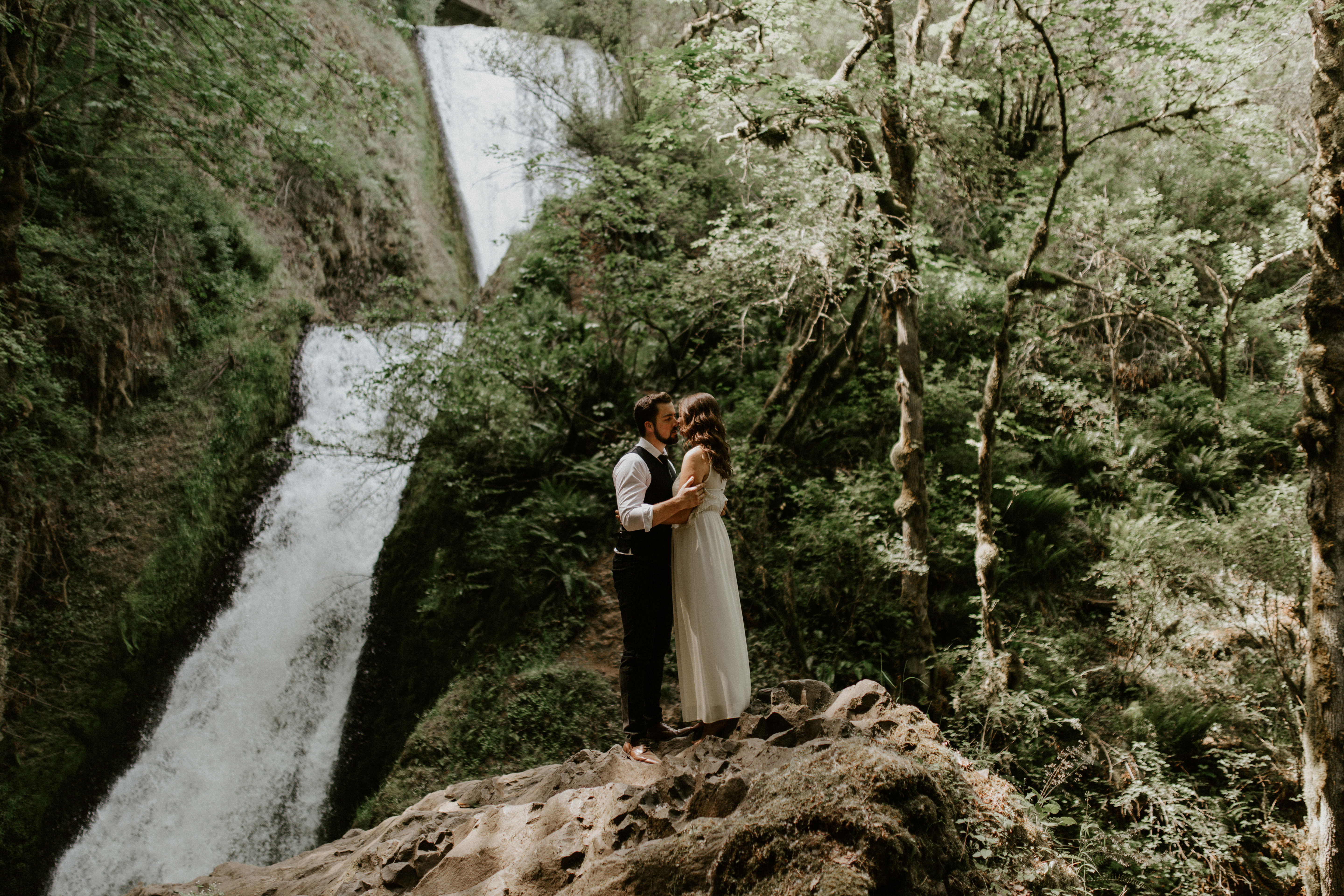 Emily and Josh kiss at Bridal Veil Falls, Oregon. Elopement photography in Portland Oregon by Sienna Plus Josh.